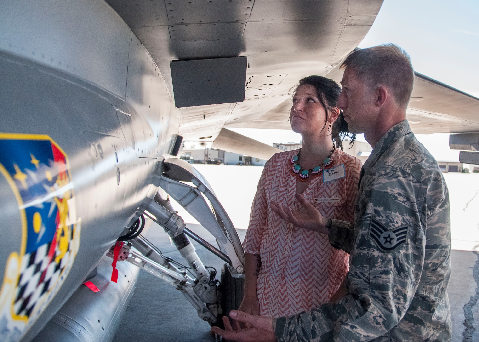 Staff Sgt. Lance Dooley, a crew chief in the 419th Aircraft Maintenance Squadron, shows his wife, Brittni, the inner workings of an F-16 during the wing’s Spouse and Significant Others Day. (U.S. Air Force photo/Staff Sgt. Crystal Charriere)