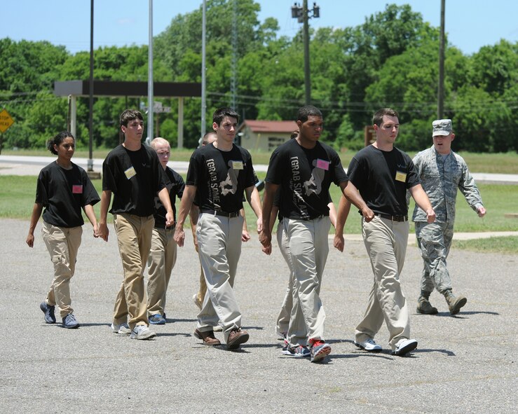 Recruits practice marching with 2nd Lt. Christopher Sullivan, 2nd Bomb Wing Public Affairs officer, on Barksdale Air Force Base, La., June 7, 2014. To help ease the transition from civilian to military life, personnel from the 2nd and 307th Bomb Wings educated recruits on what to expect at Air Force Basic Military Training. (U.S. Air Force photo/Senior Airman Benjamin Gonsier)