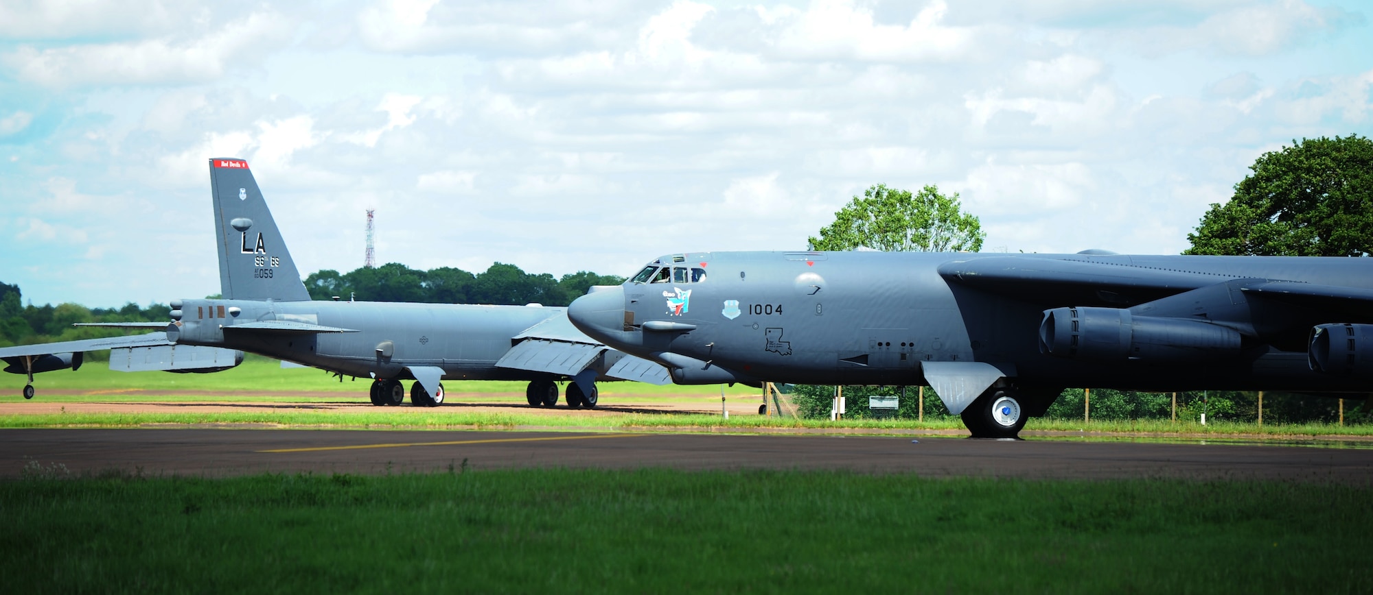 B-52 Stratofortresses from the 2nd Bomb Wing, Barksdale Air Force Base, La, and 5th Bomb Wing, Minot Air Force Base, N.D., taxi toward the runway at Royal Air Force Base Fairford, United Kingdom, June 7, 2014. The B-52s flew over the coast of Normandy, France to honor Service members who fought and sacrificed their lives on D-Day 70 years ago on June 6, 1944. (U.S. Air Force photo by Staff Sgt. Nick Wilson/Released)