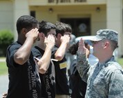 2nd Lt. Christopher Sullivan, 2nd Bomb Wing Public Affairs officer, demonstrates a proper salute to recruits on Barksdale Air Force Base, La., June 7, 2014. Sullivan taught recruits facing movements, how to properly salute and basic marching. (U.S. Air Force photo/Senior Airman Benjamin Gonsier)