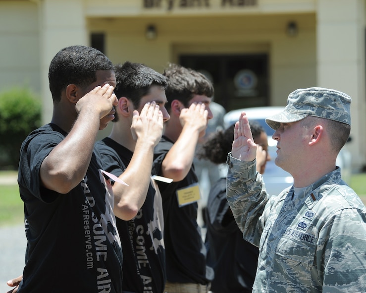 2nd Lt. Christopher Sullivan, 2nd Bomb Wing Public Affairs officer, demonstrates a proper salute to recruits on Barksdale Air Force Base, La., June 7, 2014. Sullivan taught recruits facing movements, how to properly salute and basic marching. (U.S. Air Force photo/Senior Airman Benjamin Gonsier)