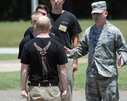 2nd Lt. Christopher Sullivan, 2nd Bomb Wing Public Affairs officer, attempts to correct a recruit during a drill procedure on Barksdale Air Force Base, La., June 7, 2014. Sullivan, a former Military Training Instructor, provided recruits a glimpse of what to expect from other MTIs at Air Force Basic Military Training. (U.S. Air Force photo/Senior Airman Benjamin Gonsier)