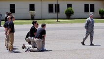 2nd Lt. Christopher Sullivan, 2nd Bomb Wing Public Affairs officer, demonstrates a facing movement to recruits on Barksdale Air Force Base, La., June 7, 2014. To help ease the transition from civilian to military life, personnel from the 2nd and 307th Bomb Wings educated recruits on what to expect at Air Force Basic Military Training. (U.S. Air Force photo/Senior Airman Benjamin Gonsier)