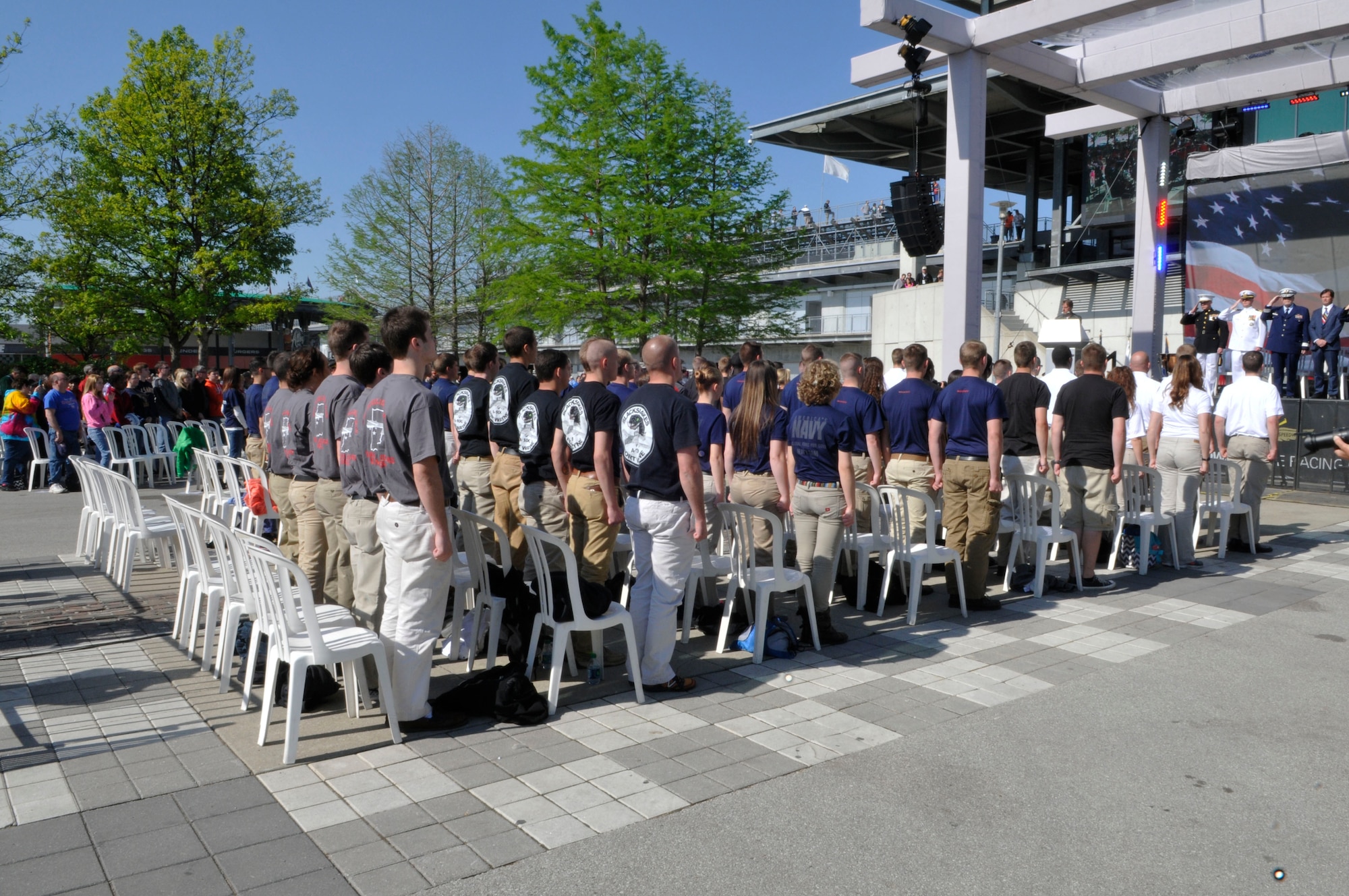 Indiana military recruits stand for the playing of the national anthem during a mass enlistment ceremony on May 18, 2014 at the Indianapolis Motor Speedway. The ceremony is held annually at the speedway during Armed Forces Weekend. (Air National Guard photo by Airman 1st Class Justin Andras/Released)