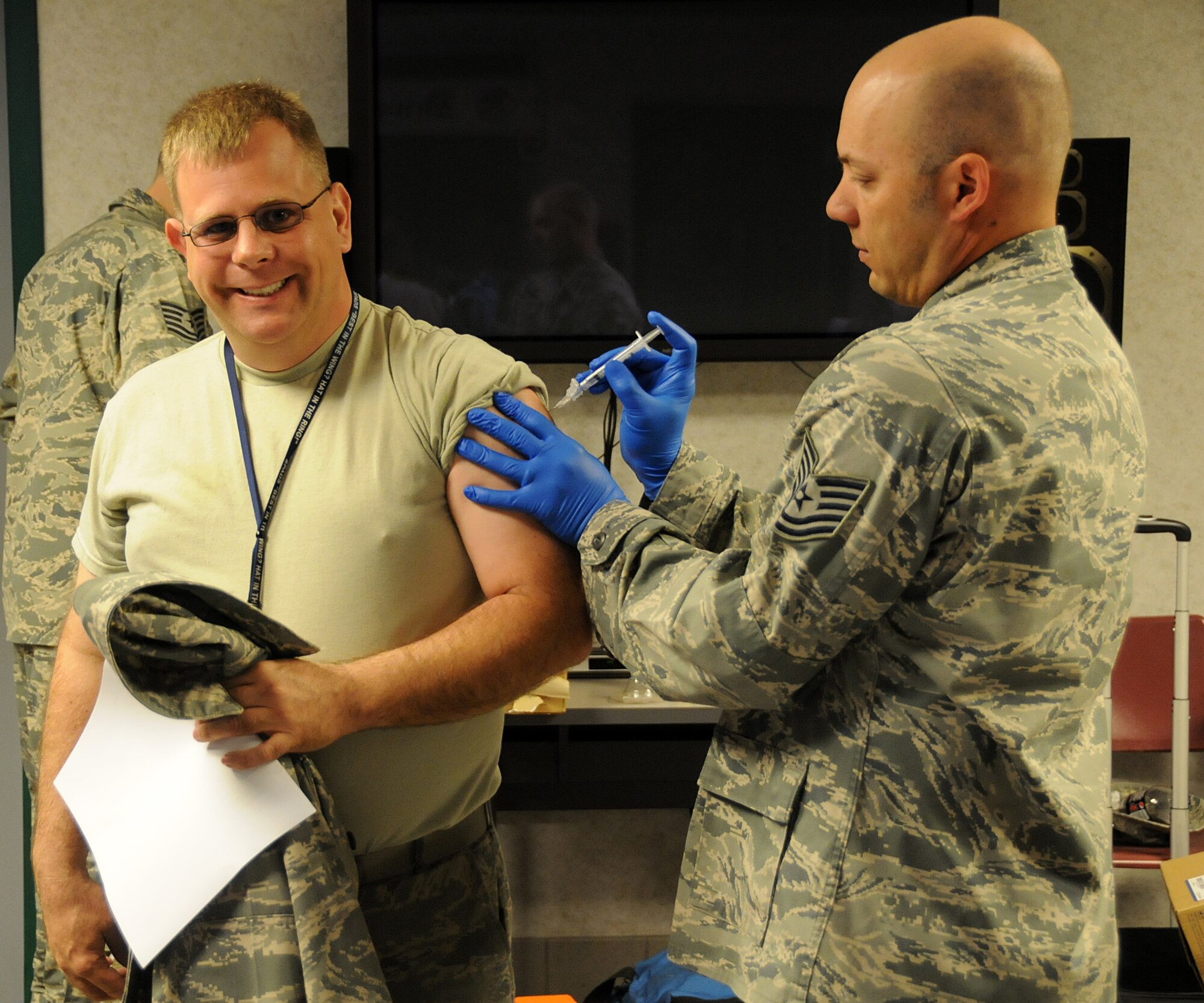 Master Sgt. Charles Cull, 192nd Aircraft Maintenance Squadron crew chief, receives his vaccination for Hepatitis B, administered by Tech. Sgt. James Folsom, 149th Fighter Squadron medical technician/squadron medical element, at Joint Base Langley-Eustis, April 27, 2014. The 192nd Medical Group conducted the mass vaccination for Hepatitis to ensure airmen are healthy and fit to complete their missions in the Air Guard. (U.S. Air National Guard photo by Airman 1st Class Johnisa B. Roberts/Released)
