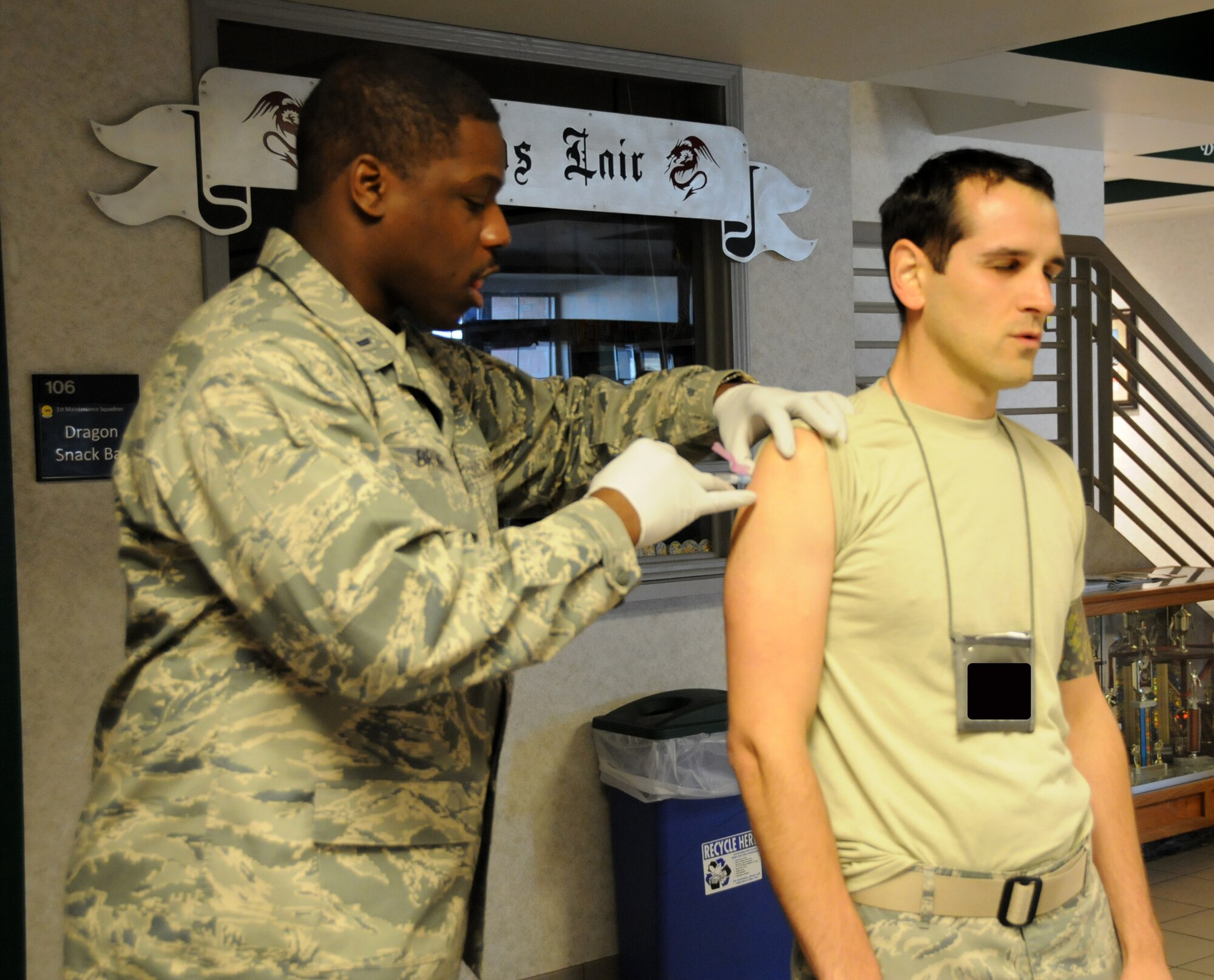 Tech. Sgt. Alberto Dimaggio, 192nd Aircraft Maintenance Squadron weapons load team chief, receives his vaccination for Hepatitis B, administered by 1st Lt. Orlando Bromell, 192nd Medical Group registered nurse, at Joint Base Langley-Eustis, April 27, 2014. The 192nd MDG conducted the mass vaccination for Hepatitis to ensure airmen are healthy and fit to complete their missions in the Air Guard. (U.S. Air National Guard photo by Airman 1st Class Johnisa B. Roberts/Released)

