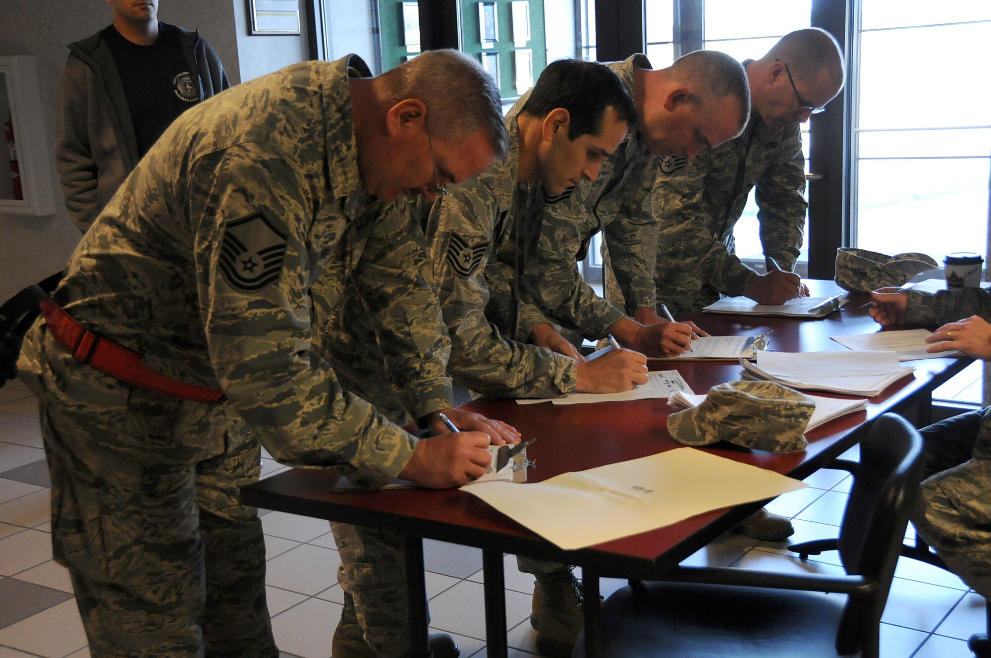 Airmen from the 192nd Fighter Wing fill out paperwork before receiving their vaccines for Hepatitis B at Joint Base Langley-Eustis, April 27, 2014. The 192nd Medical Group conducted the mass vaccination for Hepatitis to ensure airmen are healthy and fit to complete their missions in the Air Guard. (U.S. Air National Guard photo by Airman 1st Class Johnisa B. Roberts/Released)

