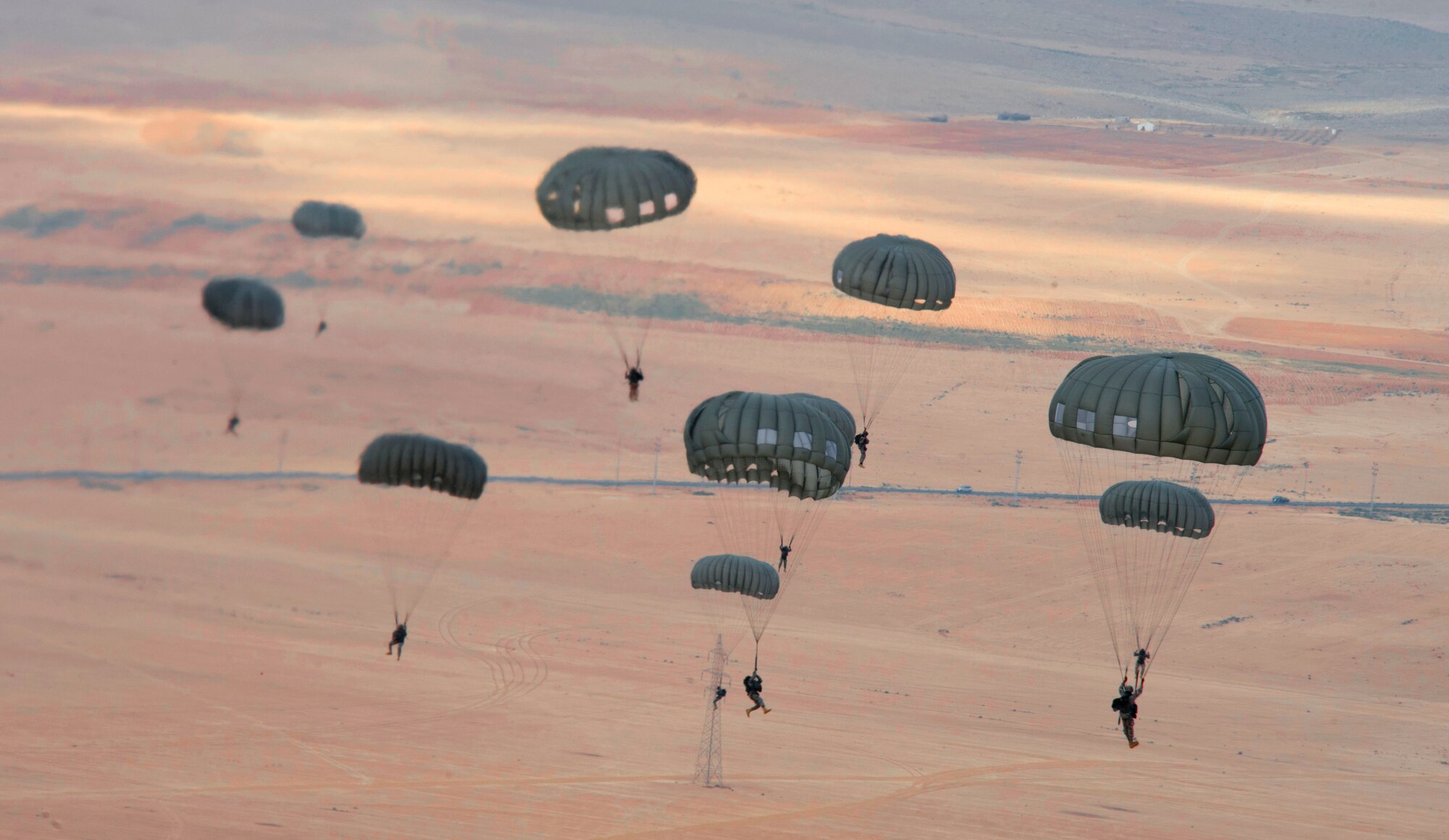 Paratroopers from various countries fly over the Jordan countryside as part of a friendship jump June 2, 2014, during Exercise Eager Lion. This event helped strengthen the military-to-military relationship between special operations forces of some of the more than 20 partner nations participating in the annual multinational exercise. (U.S. Air Force photo by Staff Sgt. Brigitte N. Brantley/Released)