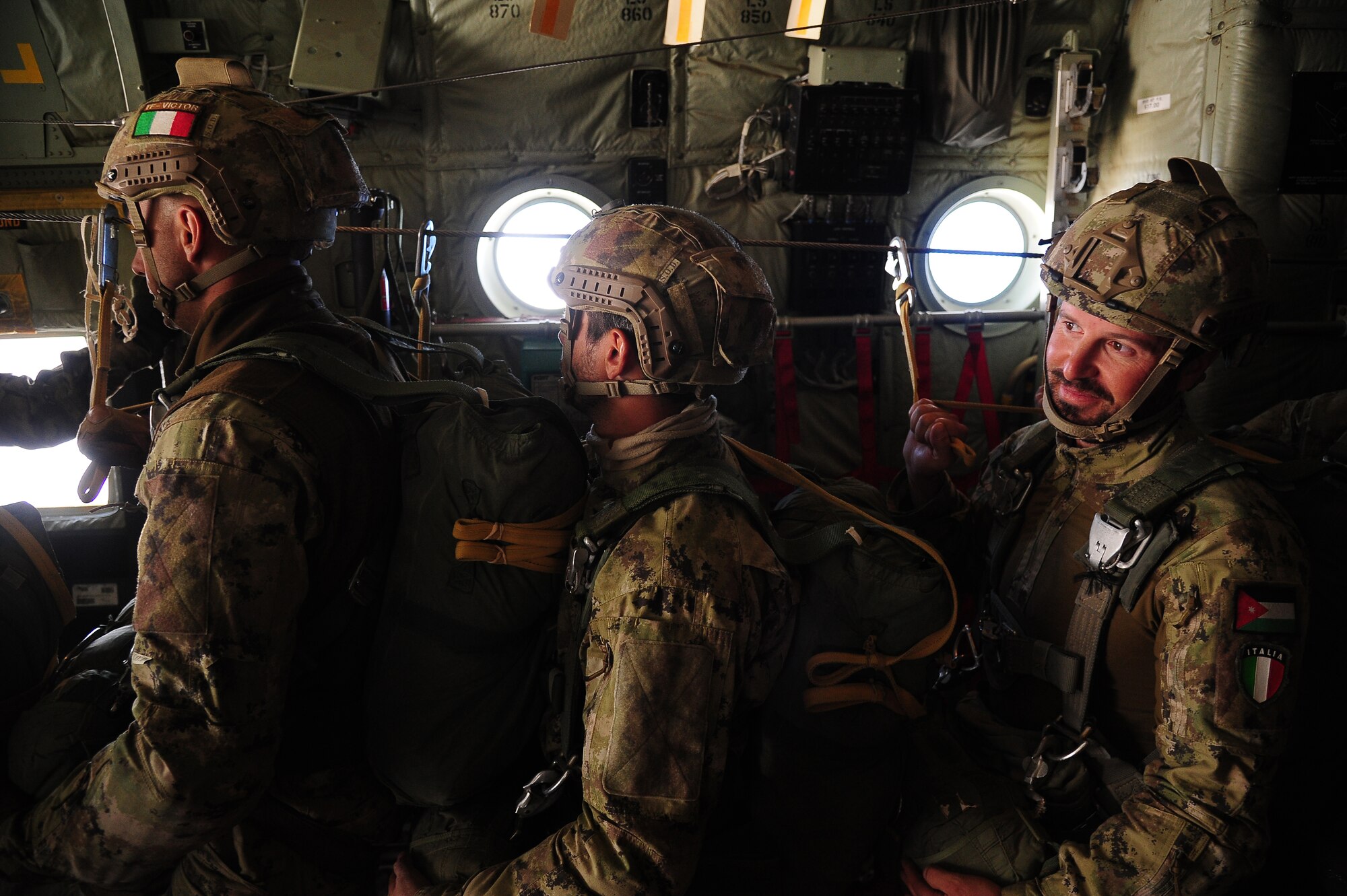 Paratroopers from the Italian Army wait for their turn to go during a friendship jump over Jordan June 2, 2014, during Exercise Eager Lion. During this fourth iteration of Eager Lion, more than 12,500 personnel from over 20 partner nations participated in scenarios that simulated possible real-world situations in the region. (U.S. Air Force photo by Staff Sgt. Brigitte N. Brantley/Released)
