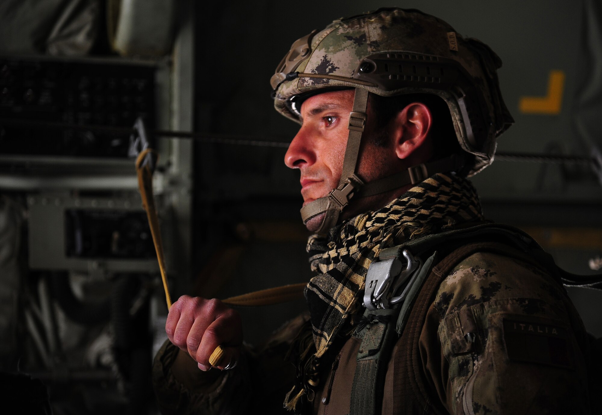 A paratrooper from the Italian Army waits for jump approval during a friendship jump over Jordan June 2, 2014, during Exercise Eager Lion. Throughout the two-week exercise, Service members from all career fields including special operations, maintainers and joint tactical air controllers interacted with their foreign counterparts as they strengthened tactical proficiency in critical mission areas. (U.S. Air Force photo by Staff Sgt. Brigitte N. Brantley/Released)