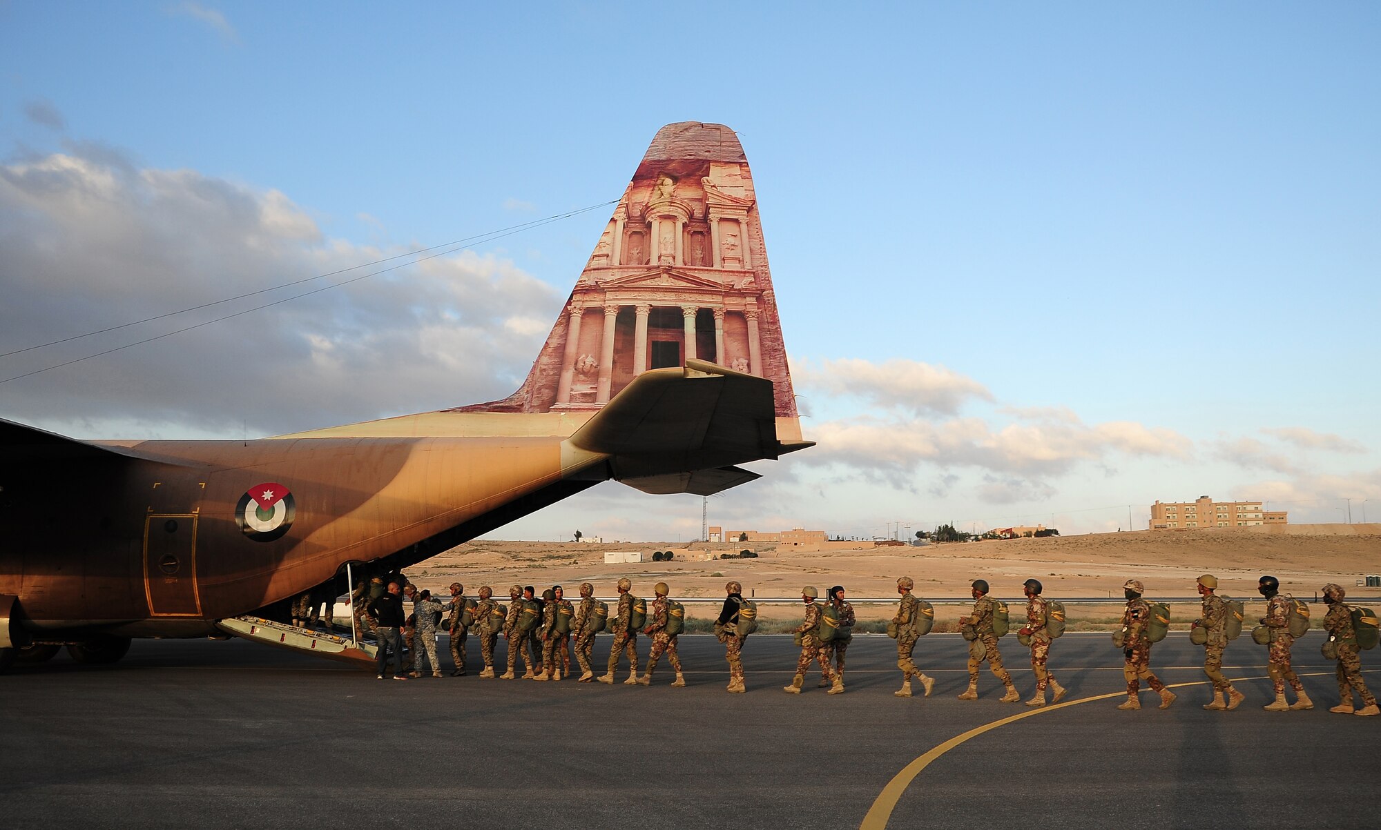 Paratroopers from various countries load onto a C-130 Hercules in preparation for a friendship jump June 2, 2014, during Exercise Eager Lion at an air base in Jordan. Interaction between multinational troops during Eager Lion helps lay the groundwork of cooperation for future possible contingencies.  (U.S. Air Force photo by Staff Sgt. Brigitte N. Brantley/Released)