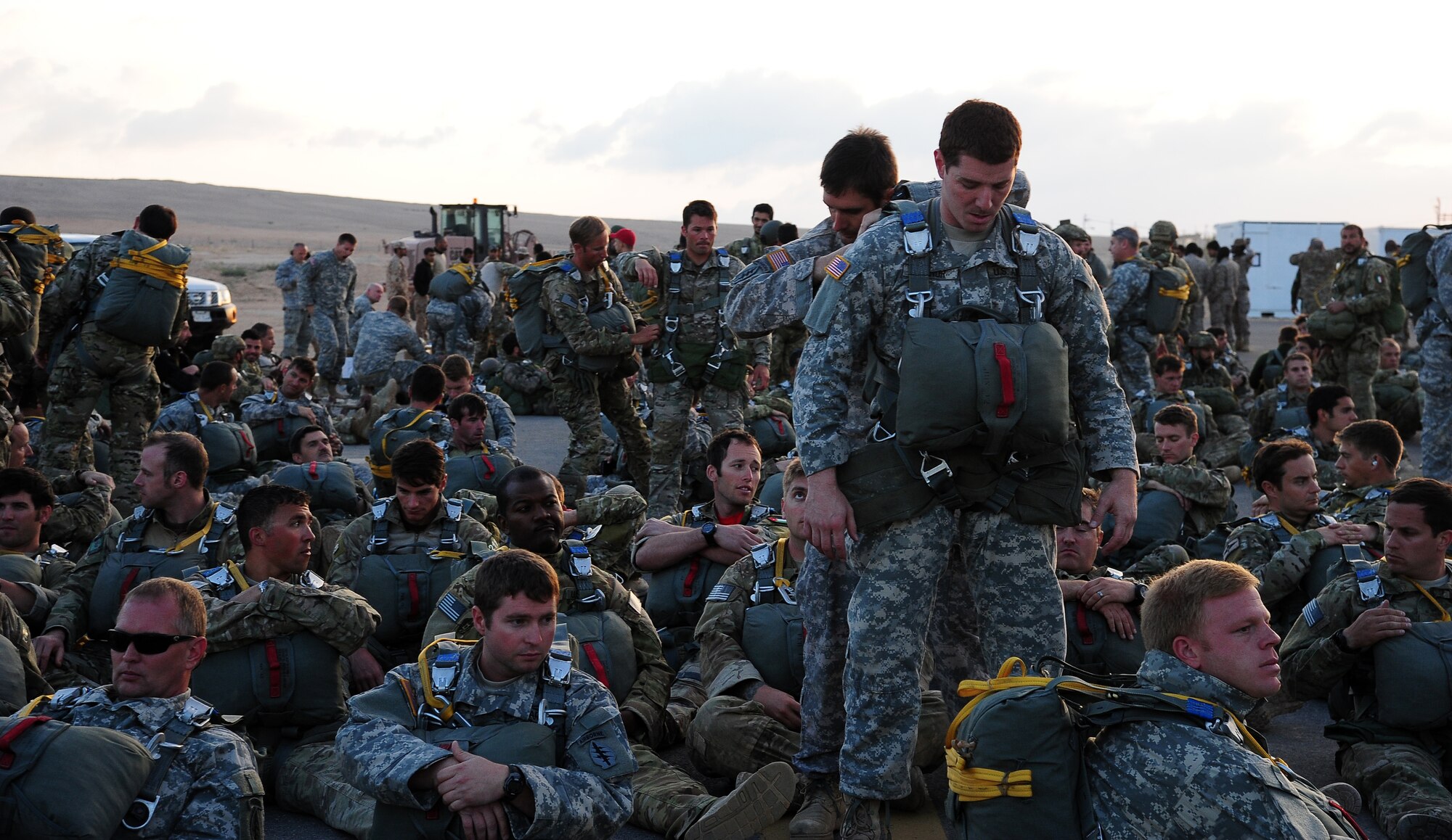Paratroopers from the U.S. Army National Guard’s 20th Special Forces Group help each other prepare for a friendship jump June 2, 2014, at an air base in Jordan during Exercise Eager Lion.  Jumpers from Australia, Pakistan, Jordan, Italy, France and many others also participated in the event. (U.S. Air Force photo by Staff Sgt. Brigitte N. Brantley/Released)