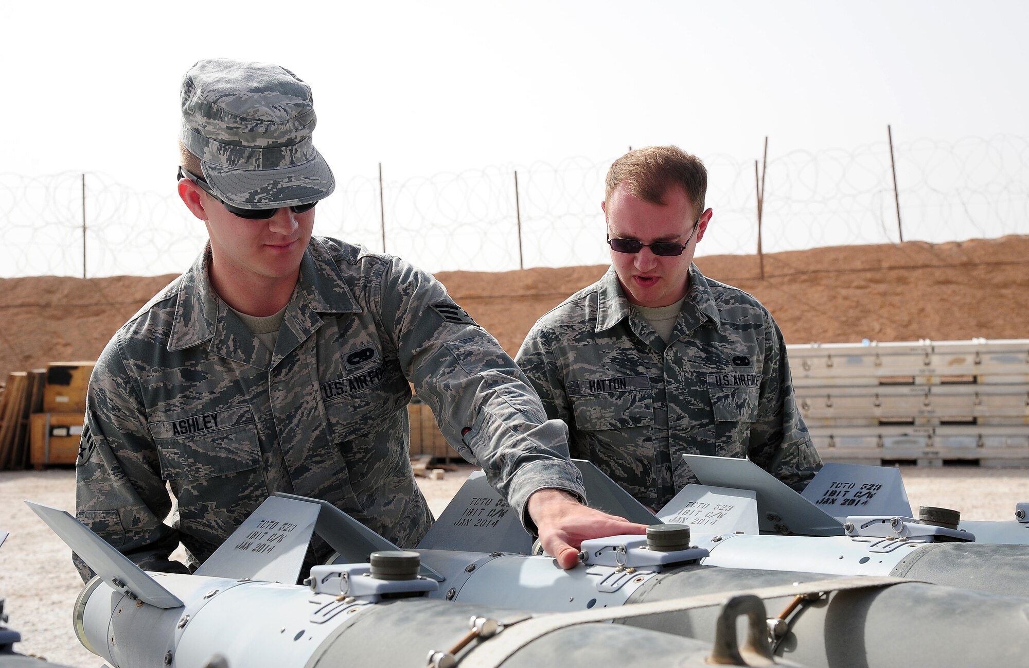 U.S. Air Force Senior Airman Matt Ashley, left, a munitions systems controller, and Airman 1st Class Clint Hatton, a munitions crew member, perform a joint direct attack munition post-assembly inspection during Exercise Eager Lion June 4, 2014, at an air base in northern Jordan. Throughout Eager Lion, F-16 Fighting Falcons from Misawa were armed with munitions for various air-to-air and air-to-ground scenarios with partner nations. (U.S. Air Force photo by Staff Sgt. Brigitte N. Brantley/Released)