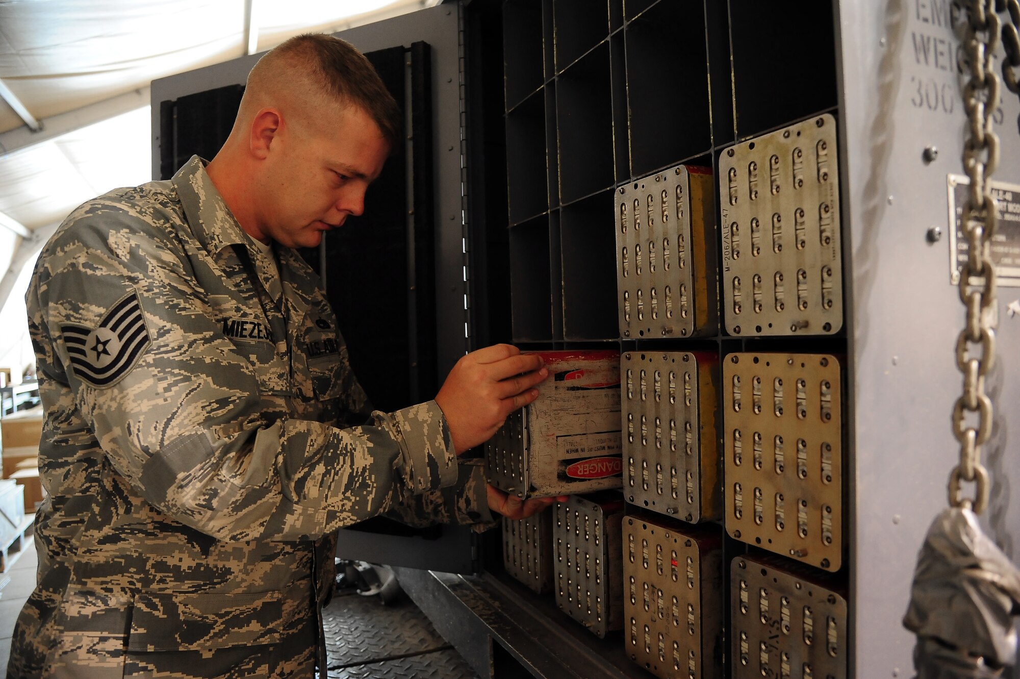 U.S. Air Force Tech. Sgt. Craig Miezejeski, a munitions controller from the 35th Maintenance Squadron at Misawa Air Base, Japan, inspects chaff and flare modules during Exercise Eager Lion June 4, 2014, at an air base in northern Jordan. Throughout the two-week multinational exercise, the Ammo Airmen provided various types of munitions for F-16 Fighting Falcons to use during scenarios that reflect modern-day security concerns. (U.S. Air Force photo by Staff Sgt. Brigitte N. Brantley/Released)