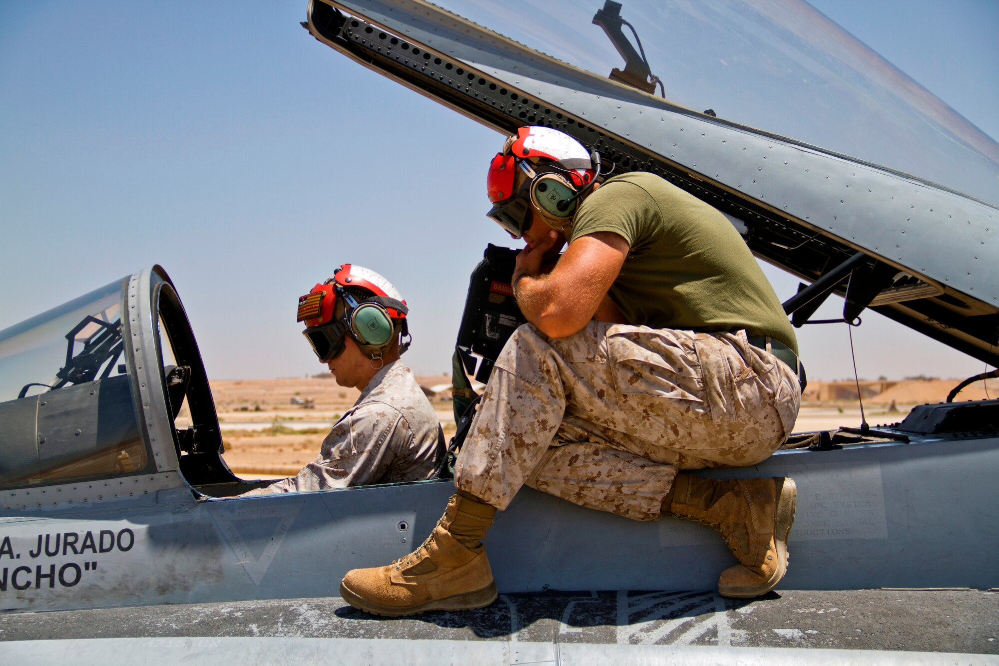 U.S. Marines from Marine Fighter Attack Squadron 314 at Marine Corps Air Station Miramar, Calif., test aircraft systems on an F-18 Hornet during Exercise Eager Lion June 1, 2014, at an air base in northern Jordan. This is the fourth year Eager Lion has been hosted by Jordan and with 12,500 participants from more than 20 countries, is larger than last year’s exercise. (U.S. Air Force photo by Staff Sgt. Tyler McLain/Released)