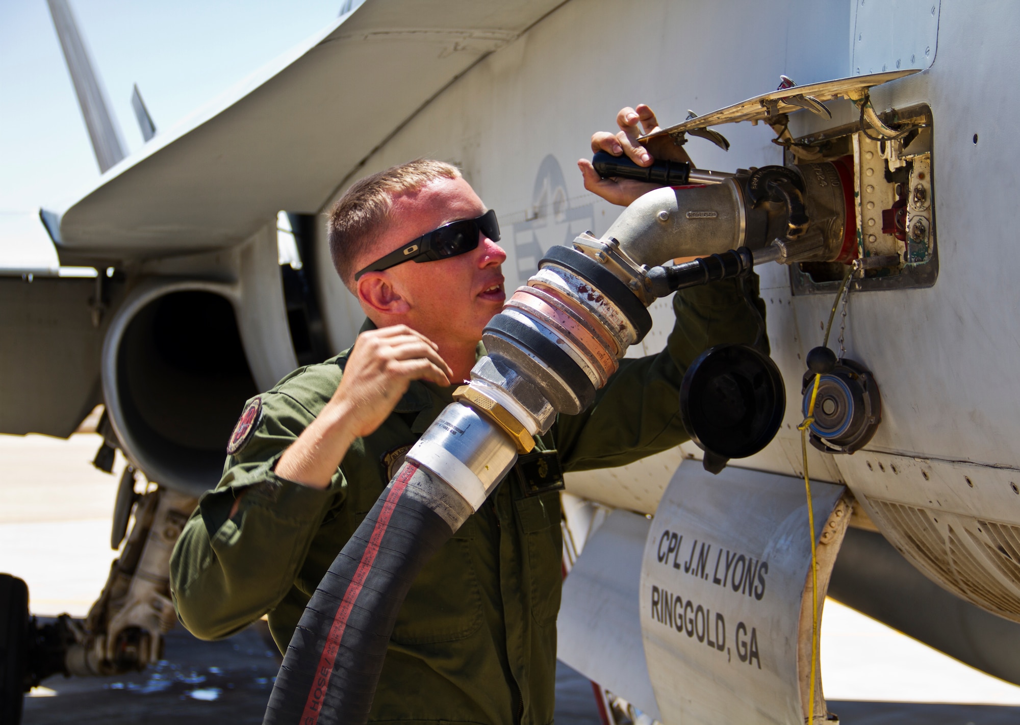 U.S. Marine Corps Cpl. Daniel Cramer, a maintainer with Marine Fighter Attack Squadron (VMFA) 314 at Marine Corps Air Station Miramar, Calif., conducts a post-flight refuel of an F-18 Hornet during Exercise Eager Lion June 1, 2014, at an air base in northern Jordan. Throughout the two-week exercise, VMFA maintainers were responsible for producing sorties that played various roles in simulated scenarios. (U.S. Air Force photo by Staff Sgt. Tyler McLain/Released)