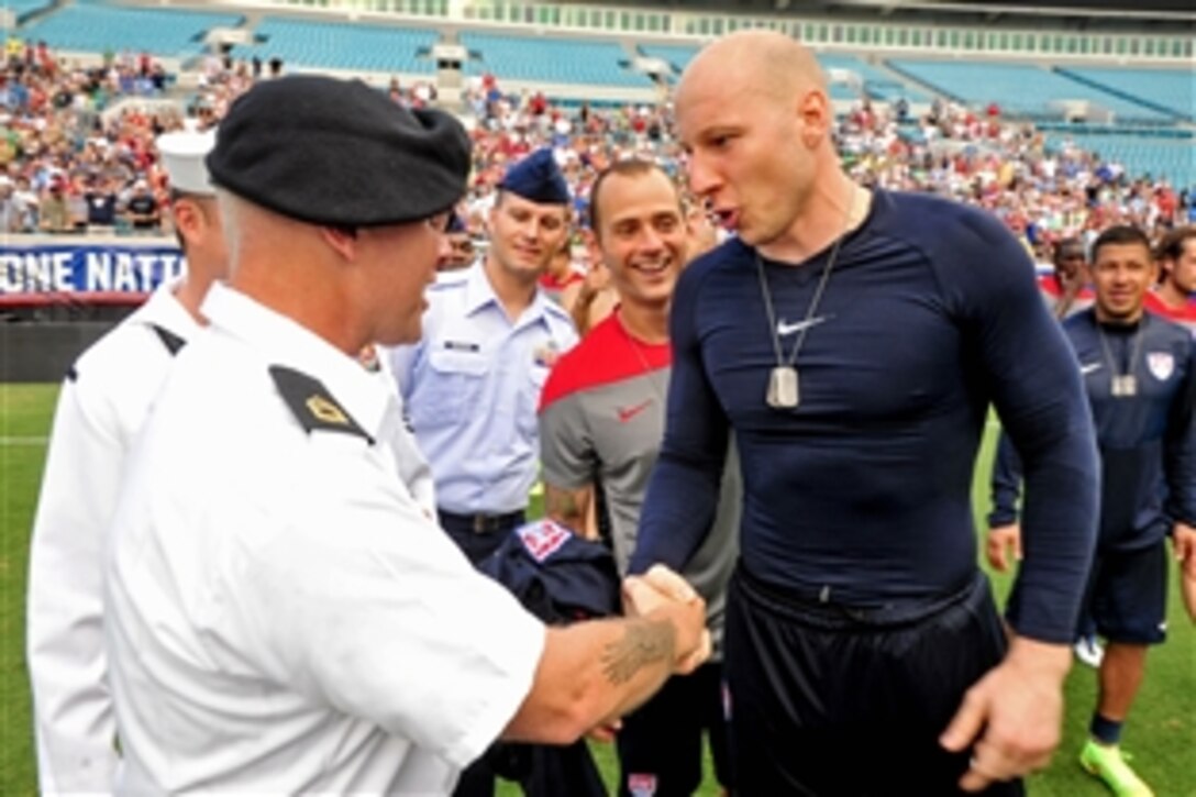 U.S. service members present dog tags to members of the USA Men’s Soccer World Cup team during a ceremony at Everbank Field, Jacksonville, Fla., June 6, 2014. The team is headed to the FIFA World Cup in Brazil. Marine Corps. Sgt. Maj. Bryan B. Battalgia, senior enlisted adviser to the chairman of the Joint Chiefs of Staff, commanded the ceremony.