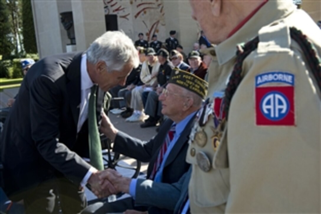 U.S. Defense Secretary Chuck Hagel meets with veterans from several nations during a ceremony commemorating the 70th anniversary of D-Day in Normandy, France, June 6, 2014.