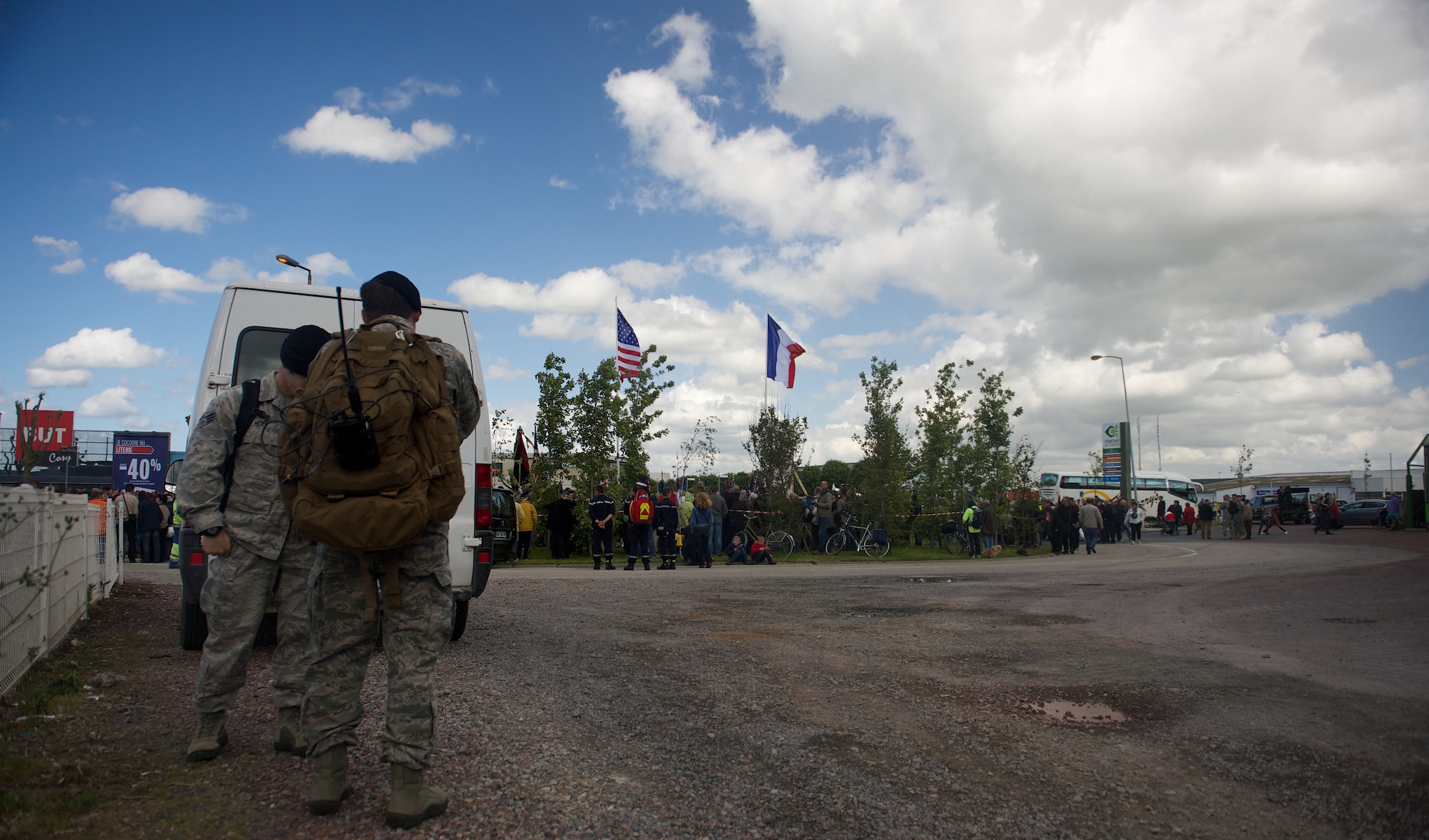 Tech. Sgt. Zachary Jacobs, front, and Senior Airman Jason Hoff coordinate a flyover behind the scenes of a 70th D-Day anniversary wreath laying ceremony, June 4, 2014, in Carentan, France. Jacobs and Hoff are joint terminal attack controllers with the 116th Air Support Operations Squadron, Washington. TACPs deploy with Soldiers to provide air support for operations on the ground. (U.S. Air Force photo/Senior Airman Alexander W. Riedel)