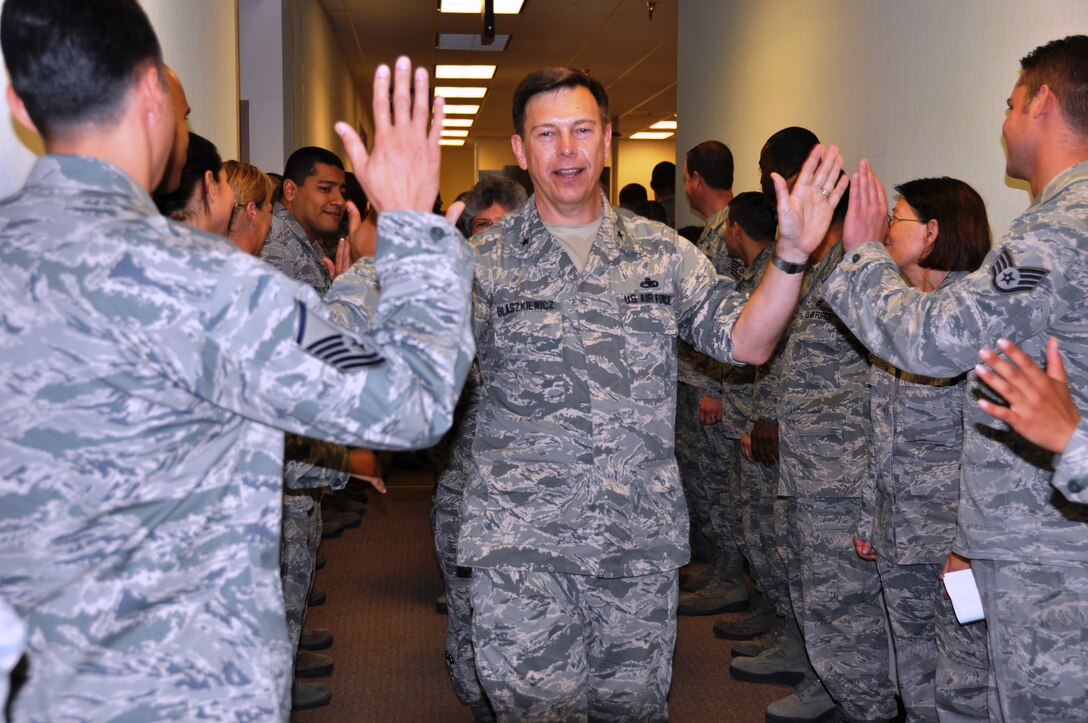 Brig. Gen.  Gary Blaszkiewicz, Director of Logistics, Headquarters Air Force Reserve Command receives high fives as he exits the 26th and 74th Aerial Port Squadron on June 8, 2014 at Joint Base San Antonio-Lackland, Texas. General Blaszkiewicz briefed the aerial porters on deployments, capabilities and training. (U.S. Air Force photo by Tech Sgt. Carlos J. Trevino)