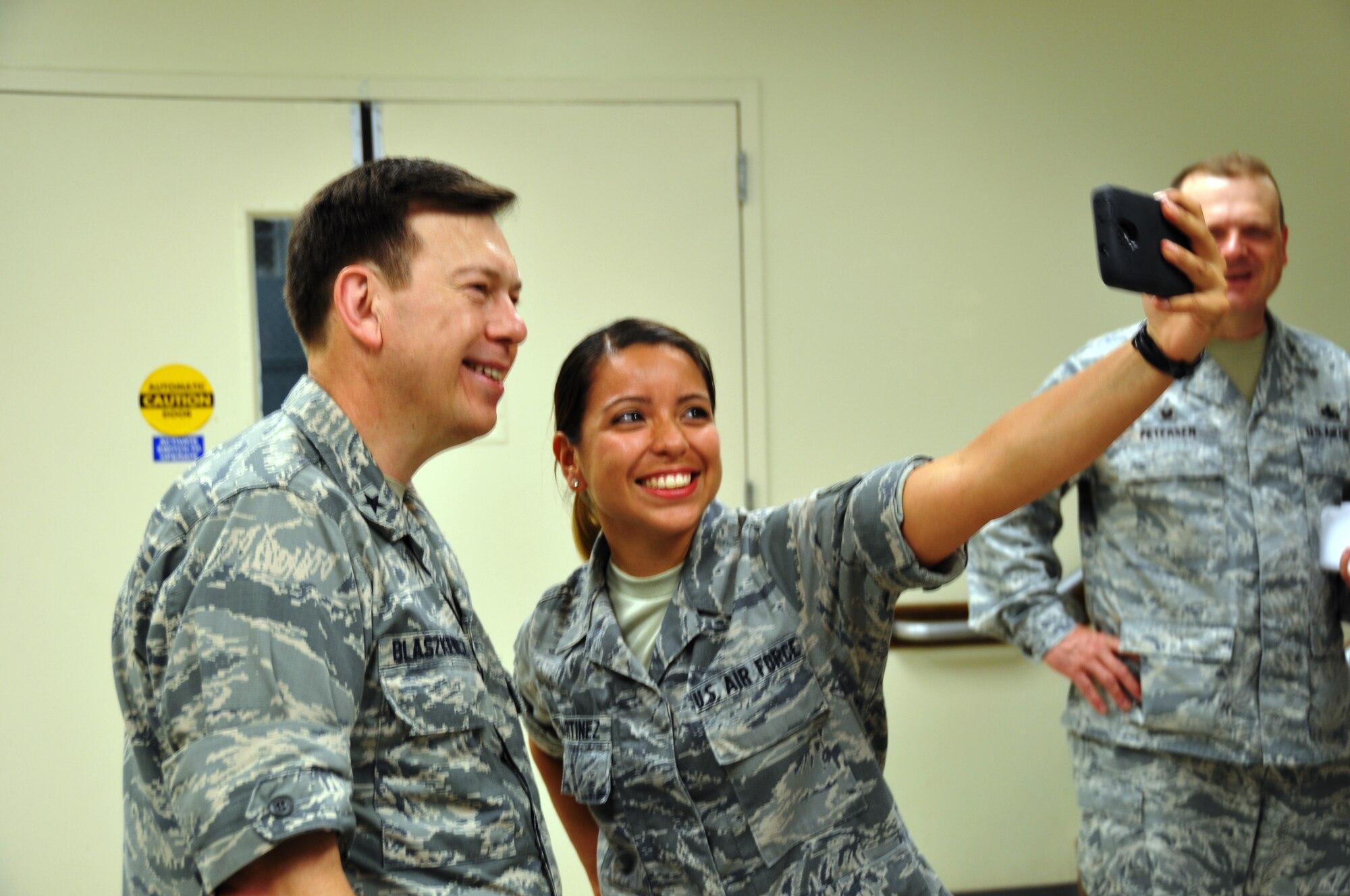 Brig. Gen.  Gary Blaszkiewicz, Director of Logistics, Headquarters Air Force Reserve Command takes a selfie with Senior Airman Rebecca Martinez, 74th Aerial Port Squadron, during his visit to the 433rd Airlift Wing on June 8, 2014 at Joint Base San Antonio-Lackland, Texas. (U.S. Air Force photo by Tech Sgt. Carlos J. Trevino)