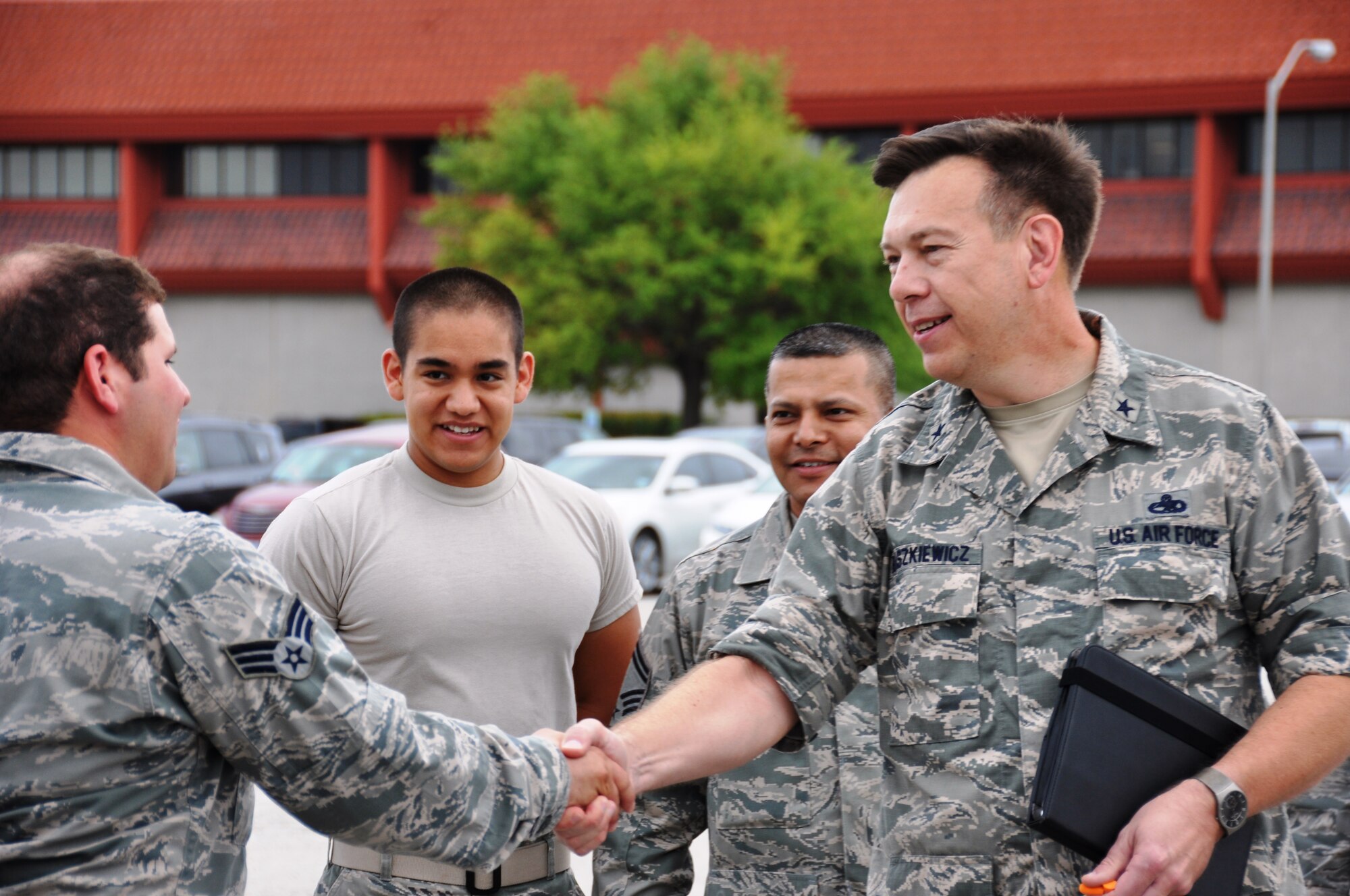 Brig. Gen.  Gary Blaszkiewicz, Director of Logistics, Headquarters Air Force Reserve Command congratulates  Senior Airman Orlando Garcia,  74th Aerial Port Squadron, after watching the Airman demonstrate his skill operating a forklift to load a K Loader on June 8, 2014 at Joint Base San Antonio-Lackland, Texas.  (U.S. Air Force photo by Tech Sgt. Carlos J. Trevino)