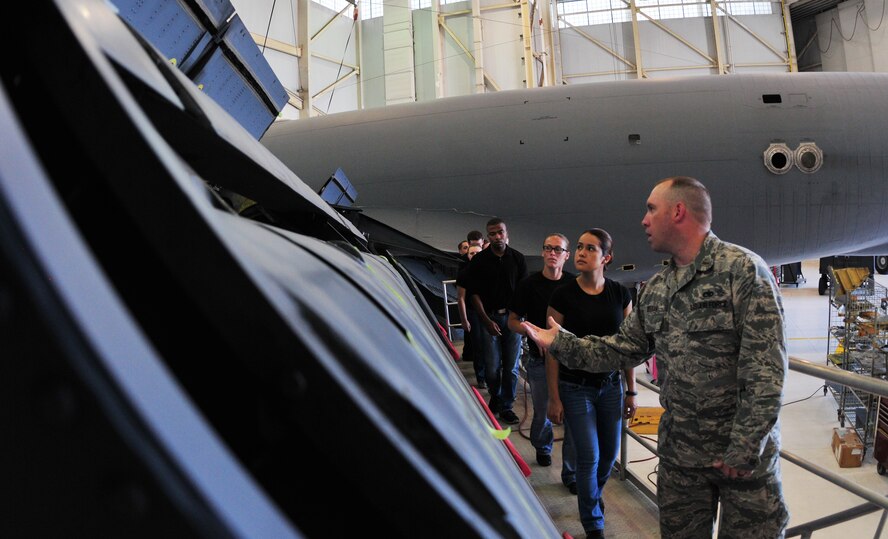 The student flight from the 161st Air Refueling Wing, Phoenix takes a tour of an opened KC-135r Stratotanker as part of their in-processing and familiarization of the base June 8, 2014. U.S. Air Force 2nd Lt. Jeremiah Deegan, 161st Aircraft Maintenance Squadron officer, explains how ailerons work as he leads the students through the hanger. Capt. Jeff Robertson (not pictured), 161st Force Support Squadron readiness officer and student flight officer-in-charge explains the purpose of the student flight: “It [student flight] is a transition period from the time the students swear in until they leave for boot camp. We want them to soak up as much knowledge as possible about the unit, about the Air Force. This way they will have familiar faces to greet them when they come home.” 