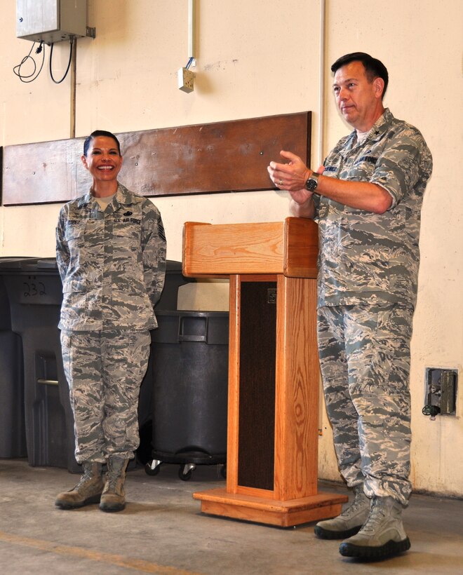 Brig. Gen.  Gary Blaszkiewicz, Director of Logistics, Headquarters Air Force Reserve Command applauds Senior Master Sgt. Elizabeth Lopez, 433rd Logistics Readiness Squadron Quality Assurance Superintendent, on June 7, 2014 after presenting her with one of his coins for building a program which could be used as a benchmark for the career field. (U.S. Air Force photo by Tech Sgt. Carlos J. Trevino)