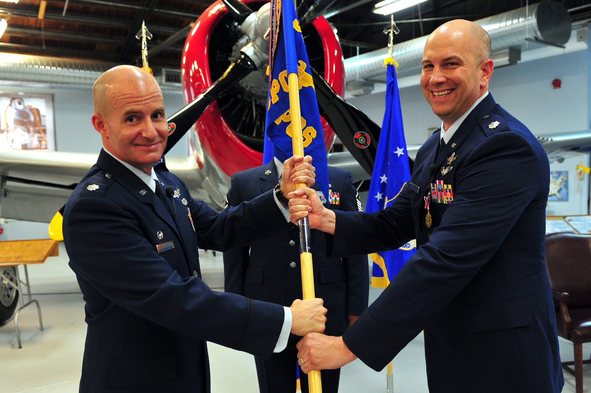 Air Force Reserve Lt. Col. Michael A. Assid, acting 310th Operations Group commander (left), presents the 380th Space Control Squadron guidon to AF Reserve Lt. Col. Dean D. Sniegowski June 7, 2014, on Peterson Air Force Base, Colo. Sniegowski assumed command of the squadron during the ceremony.
(U.S. Air Force photo/Tech. Sgt. Nicholas B. Ontiveros)