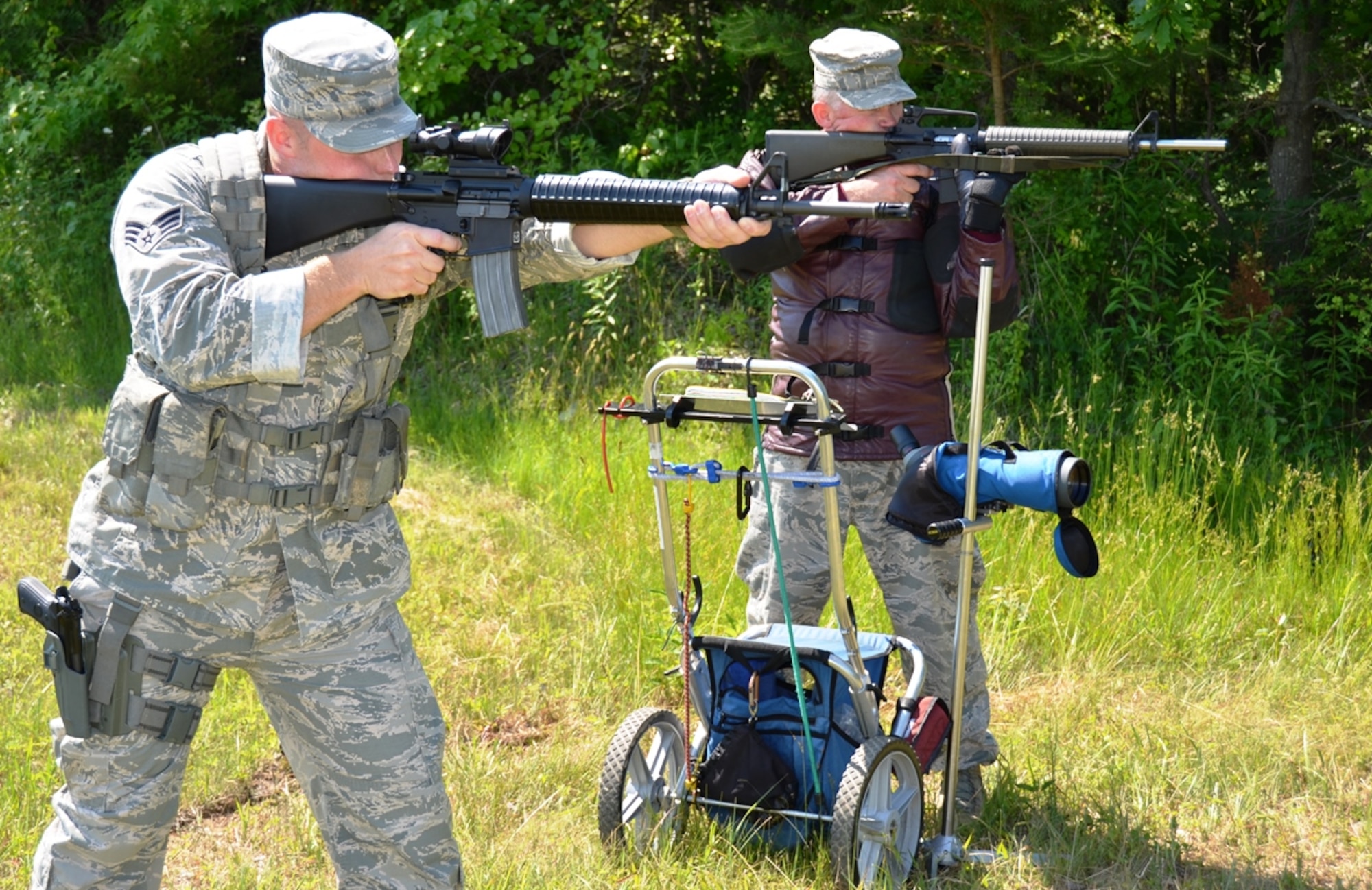 Maryland Air National Guardsman Senior Airman Evan Jones, right, electronic warfare pod technician, 175th Maintenance Squadron, and Master Sgt. Greg Blackstock, intelligence operations specialist, 175th Intelligence Squadron display their shooting technique with M16 rifles at Warfield Air National Guard Base in Baltimore, Md. on June 8, 2014. Jones has been awarded the Air Force Distinguished Rifleman and Pistol Badges this year and Blackstock earned the badges in 2000 and now mentors Jones. Jones is displaying the National Guard Combat team discipline and Blackstock is displaying the high power rifle team discipline. (U.S. Air National Guard photo by Tech. Sgt. David Speicher/RELEASED)
