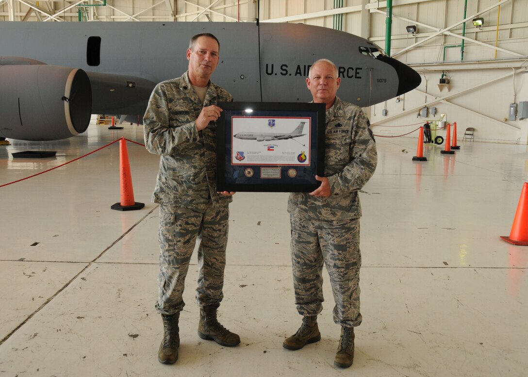 U.S. Air Force Lt. Col. Charles Sanders, left, presents Chief Master Sgt. Billy Gressett with the 186th Air Refueling Wing plaque at Key Field Air National Guard Base, June 8, 2014.  Gressett retired from the Maintenance Squadron with more than 38 years of service. (U.S. Air National Guard photo by Senior Airman Jessica Fielder/Released) 