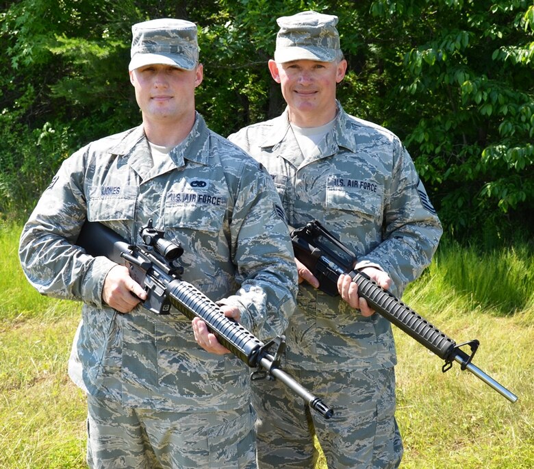 Maryland Air National Guardsman Senior Airman Evan Jones, right, electronic warfare pod technician, 175th Maintenance Squadron, and Master Sgt. Greg Blackstock, intelligence operations specialist, 175th Intelligence Squadron stands with their competition weapons at Warfield Air National Guard Base in Baltimore, Md. on June 8, 2014. Jones has been awarded the Air Force Distinguished Rifleman and Pistol Badges this year and Blackstock earned the badges in 2000 and now mentors Jones. (U.S. Air National Guard photo by Tech. Sgt. David Speicher/RELEASED)