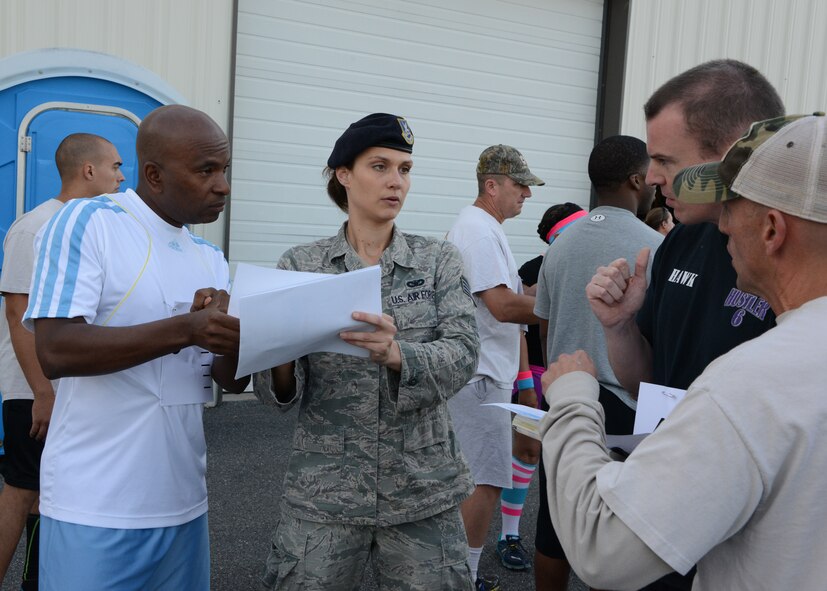 U.S. Air Force Staff Sgt. Keri Wanner (middle), 175th Security Forces Squadron, goes over the Fire Team Challenge course map with members of the 175th Security Forces Squadron at Warfield Air National Guard Base, Baltimore, Md., June 8, 2014.  The Fire Team Challenge was a two mile run with six challenge stations that each four person team had to complete before moving on to the next leg.  The stations were a mix of physical fitness challenges, self-aid and buddy care, military knowledge and firearms knowledge.  (U.S. Air National Guard Photo by Tech. Sgt. Christopher Schepers)