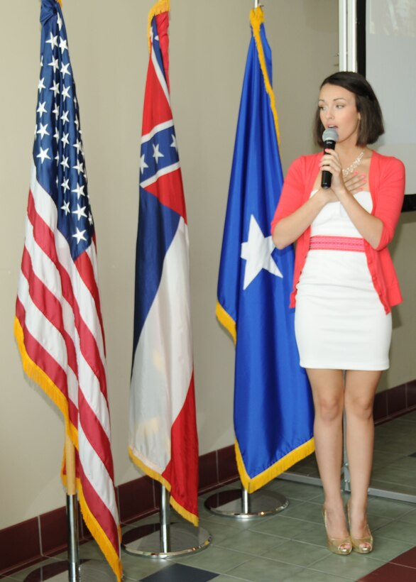 Grace Strickland, daughter of U.S. Air Force Col. Uriel Strickland, sings the national anthem at her father's retirement ceremony at Key Field Air National Guard Base, June 7, 2014. Col. Strickland retired from the 286th Air Operations Group with more than 20 years of service.  (U.S. Air National Guard photo by Senior Airman Jessica Fielder/Released)
