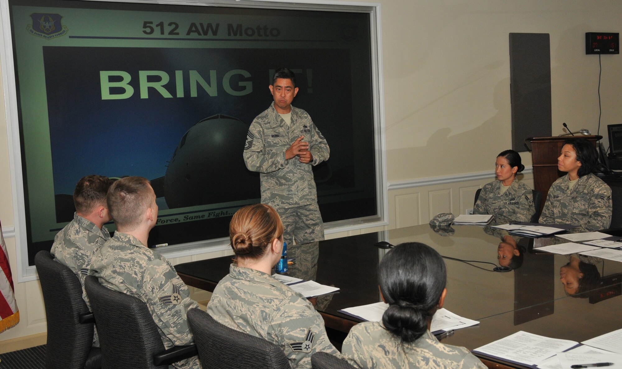 Chief Master Sgt. Brian Wong, 4th Air Force command chief, speaks with 512th Airlift Wing reservists during a Unit Training Assembly June 7, 2014, at Dover Air Force Base, Del. Wong thanked the Airmen for their commitment to the Air Force Reserve mission and sought feedback on how to improve processes regarding pay, training, lodging and mission support. (U.S. Air Force photo/Senior Airman Joe Yanik)