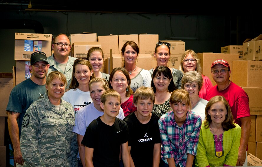 Volunteers from the 442nd Fighter Wing family and the Warrensburg United way poses for a photo at the Warrensburg United Way June 7, 2014, Warrensburg, Mo. About 100 boxes were filled for care packages to send to deployed members of the 442nd Fighter Wing. (U.S. Air Force photo by Senior Airman Daniel Phelps/Released)