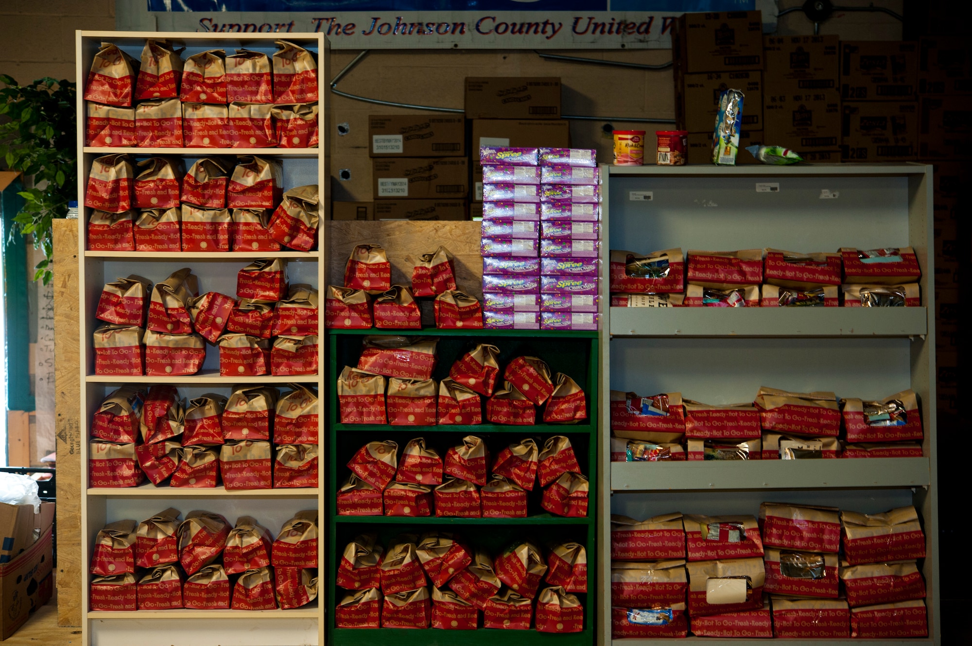 Shelves are lined with bags for care packages at the Warrensburg United Way June 7, 2014, Warrensburg, Mo. Boxes were filled for care packages to send to deployed members of the 442nd Fighter Wing. (U.S. Air Force photo by Senior Airman Daniel Phelps/Released)