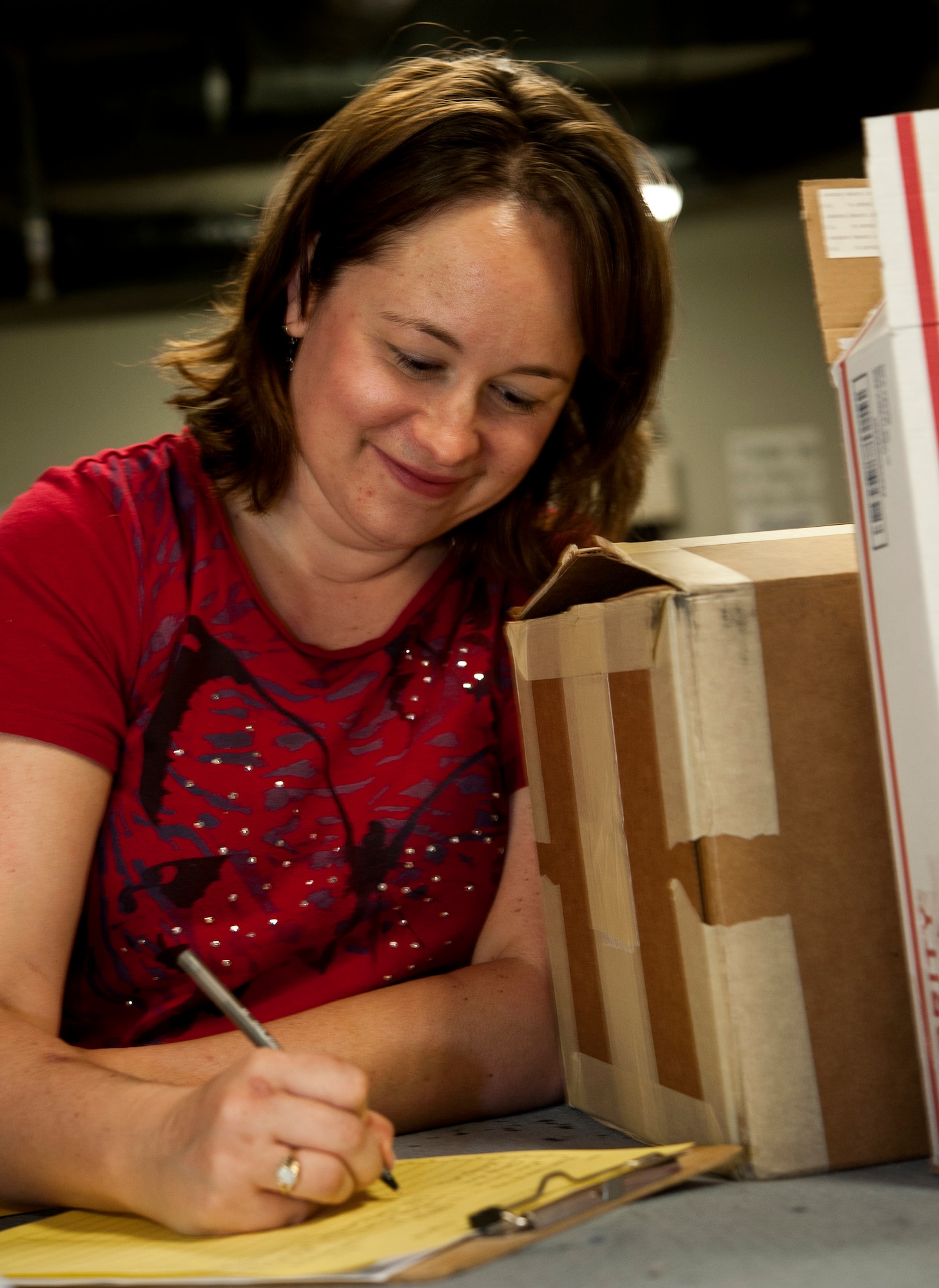 Kelly Casler, wife of Maj. David Casler, 442nd Operations Group, collects information for the care packages at the Warrensburg United Way June 7, 2014, in Warrensburg, Mo. Boxes were filled for care packages to send to deployed members of the 442nd Fighter Wing. (U.S. Air Force photo by Senior Airman Daniel Phelps/Released)