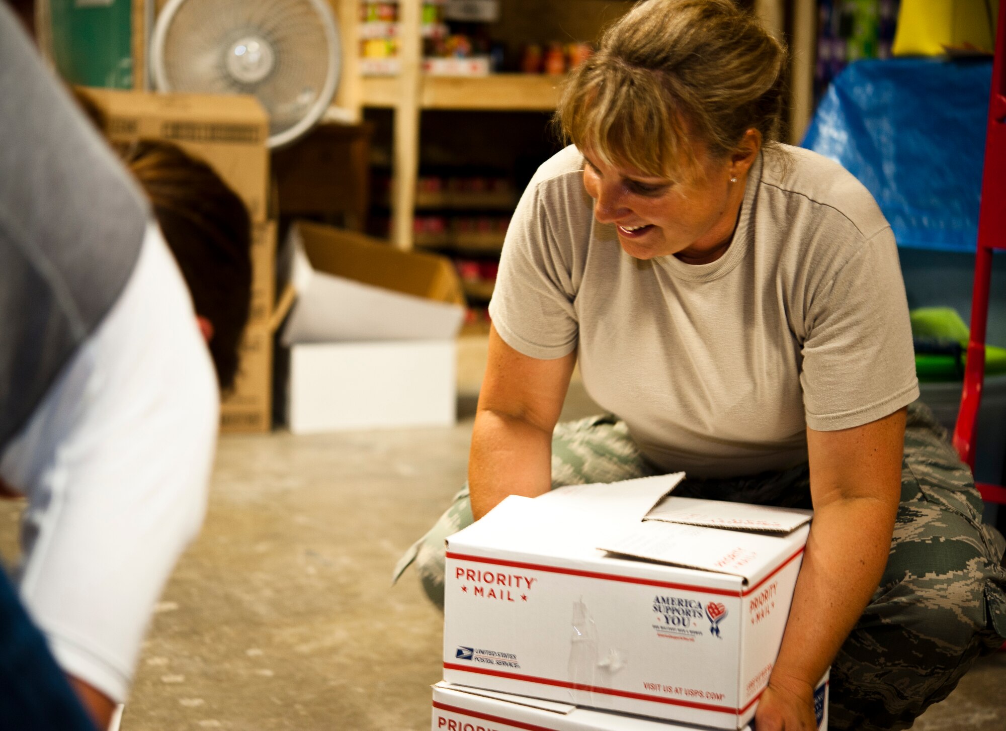 Senior Master Sgt. Shevaun McRoberts, 442nd Logistics Readiness Squadron logistics supply manager, lifts care packages at the Warrensburg United Way June 7, 2014, in Warrensburg, Mo. Boxes were filled for care packages to send to deployed members of the 442nd Fighter Wing. (U.S. Air Force photo by Senior Airman Daniel Phelps/Released)