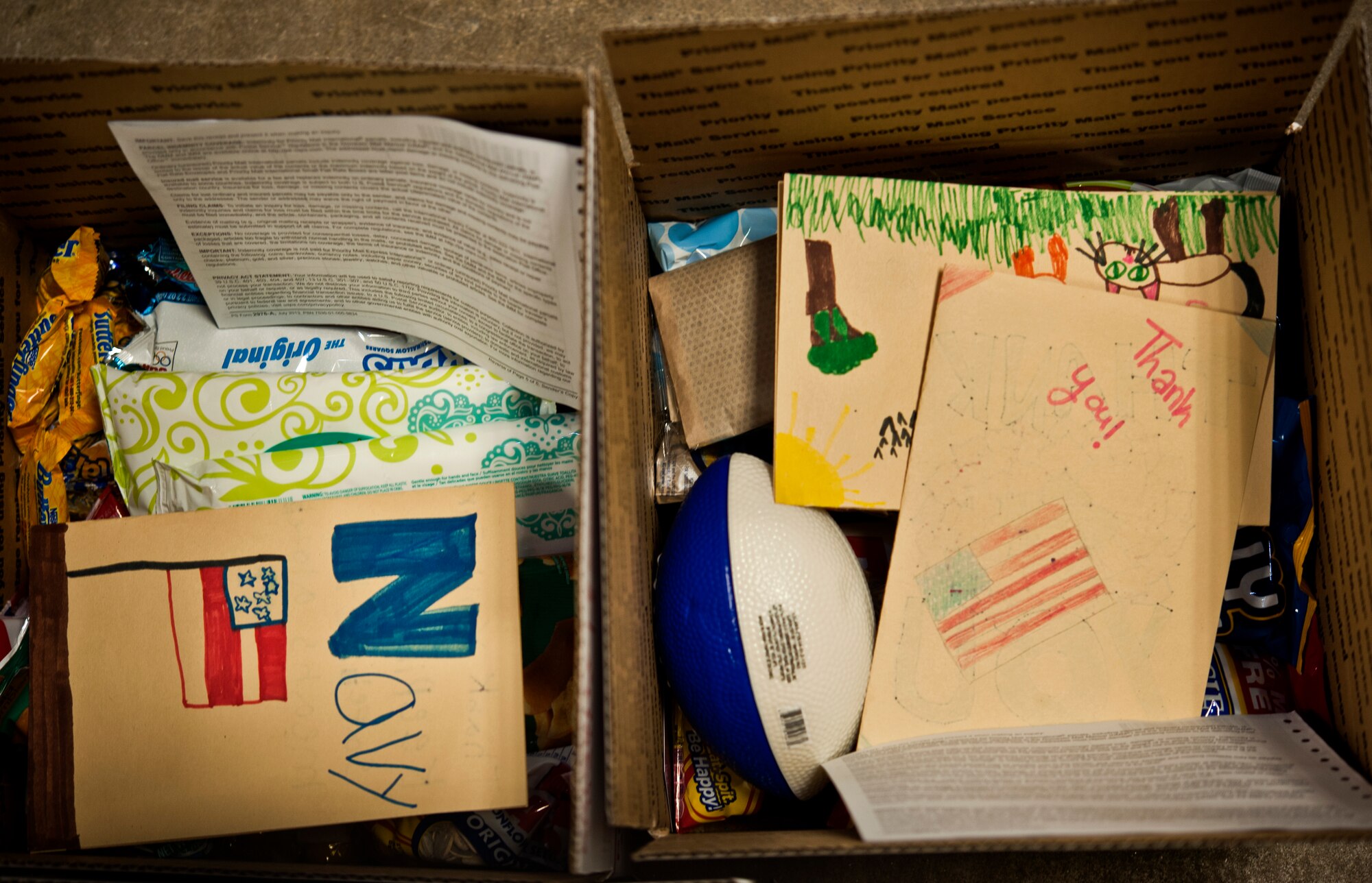 A box filled with goods for deployed Airmen lies on the ground in a building in Warrensburg, Mo., June 7, 2014. Boxes were filled for care packages to send to deployed members of the 442nd Fighter Wing. (U.S. Air Force photo by Senior Airman Daniel Phelps/Released)