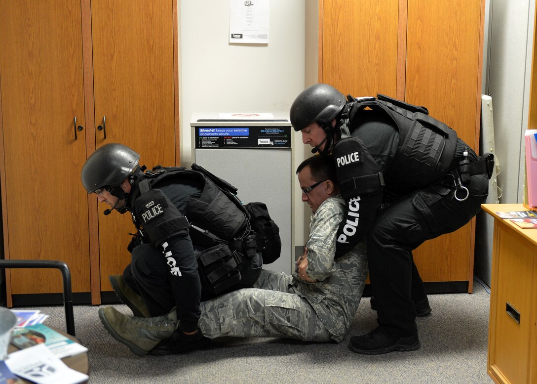 Two officers of the Lincoln Police Department rescue a simulated injured Airman during a mass casualty exercise at the Nebraska Air National Guard Base, Lincoln, Neb., April 24, 2014. The Nebraska National Guard partnered with Lincoln Police Department, and various emergency response agencies during the first ever exercise of this kind. 