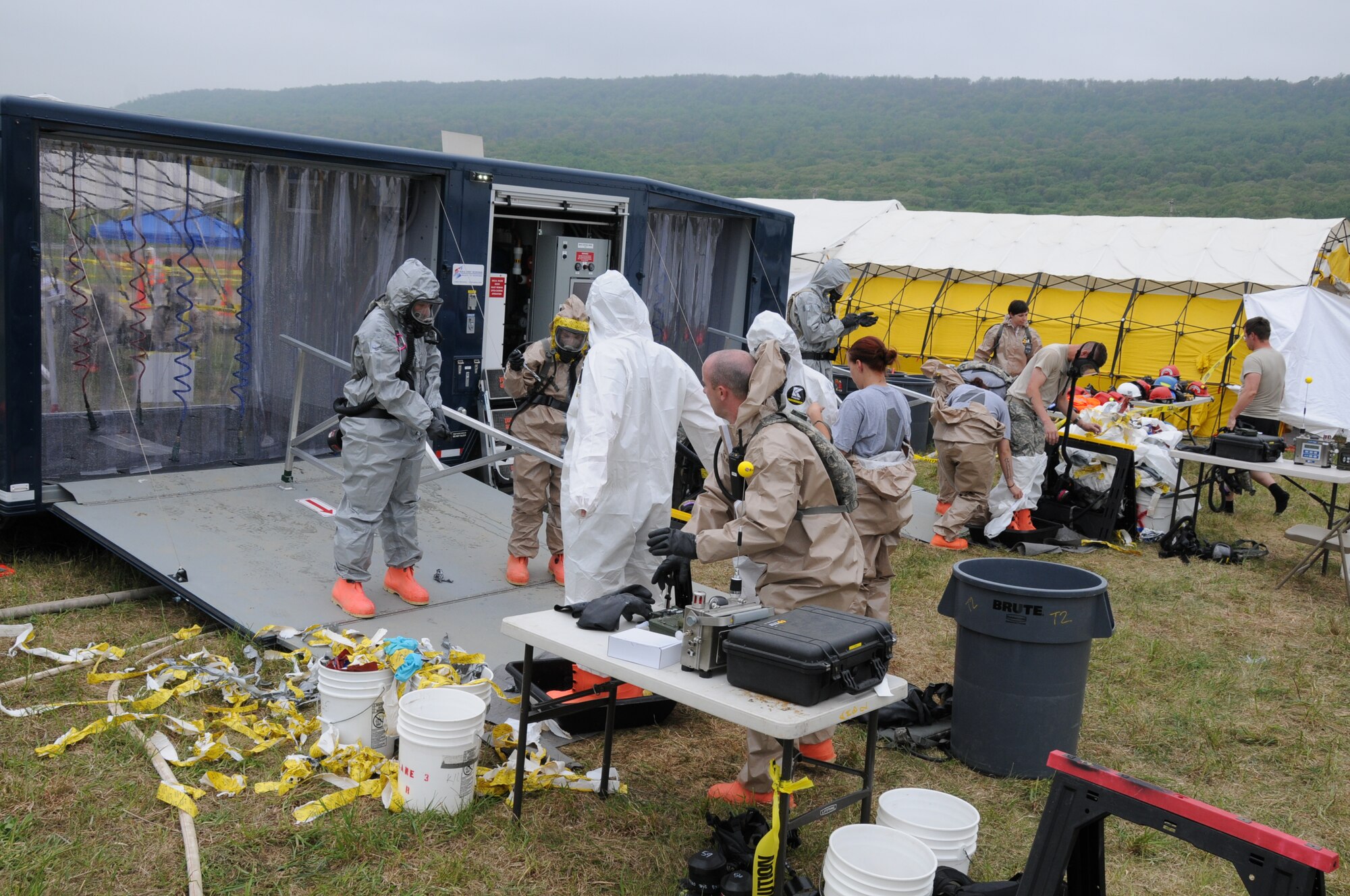 Chemical, Biological, Radiological, Nuclear, and Explosive (CBRNE) Enhanced Response Force Package (CERFP) personnel have their suits removed after passing through chemical decontamination showers at Fort Indiantown Gap, Pa., May 14, 2014.  The three-day Vigilant Guard exercise is designed to evaluate and enhance the integration of local, state, and federal responders under one command structure.  This is the first time the Virginia Air National Guard is participating in this exercise with six other states and the Commonwealth of Puerto Rico.  The CERFP conducts tasks associated with incident management, search and rescue, mass casualty decontamination, medical triage, and fatality recovery.  (U.S. Air National Guard photo by Master Sgt. Carlos J. Claudio/Released)