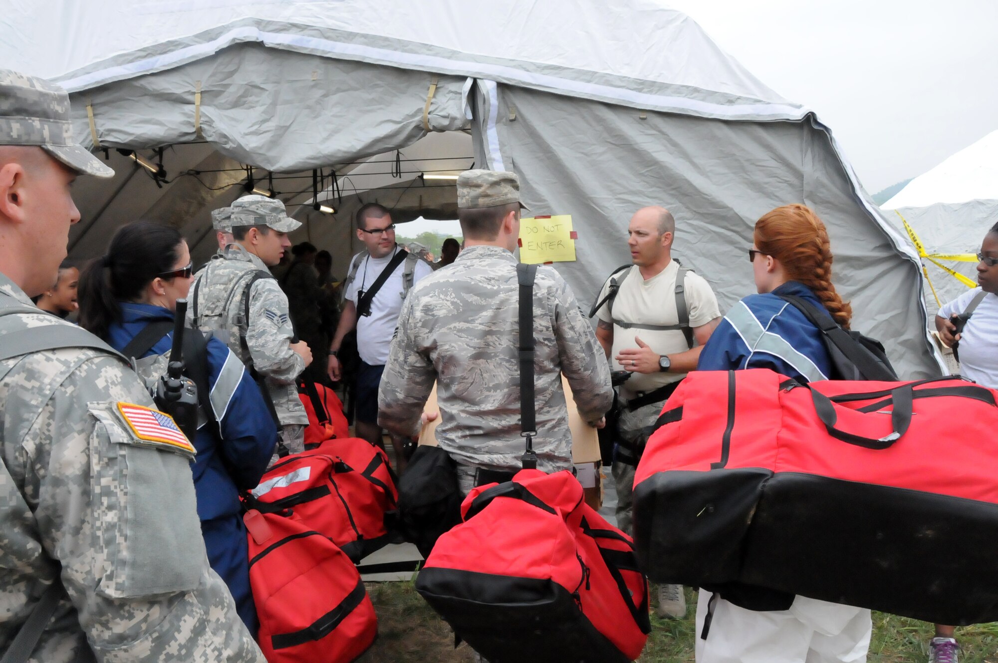 Tech. Sgt. James Folsom (center), 192nd Fighter Wing Medical Group medical technician, briefs airmen from the Pennsylvania Air National Guard on the medical triage system before handing over the jobs to them during the three-day Vigilant Guard exercise at Fort Indiantown Gap, Pa., May 14, 2014.  The 192nd MDG participated in the exercise to enhance their Chemical, Biological, Radiological, Nuclear, and Explosive (CBRNE) Enhanced Response Force Package (CERFP) training in which they used the medical triage to assess “patients” and direct them to the correct tent for treatment.  The CERFP conducts tasks associated with incident management, search and rescue, mass casualty decontamination, medical triage, and fatality recovery.  (U.S. Air National Guard photo by Airman 1st Class Johnisa B. Roberts/Released)