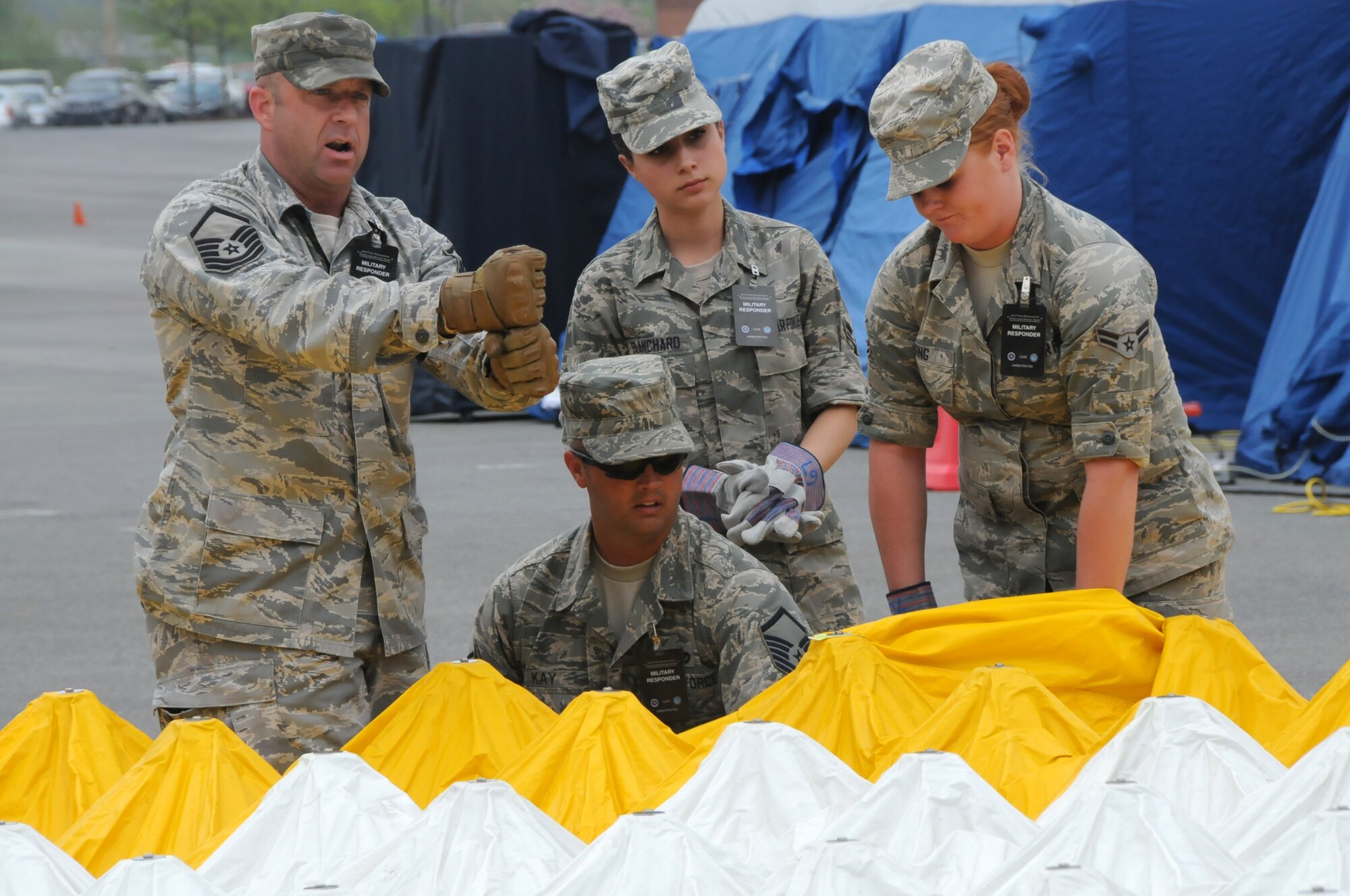 Master Sgt. Leon Joyal, 192nd Fighter Wing Medical Group medical logistics person for CERFP; Airman 1st Class Jessica Blanchard, 192nd MDG medical technician; Airman 1st Class Katelyn King, 192nd MDG Medic; and Master Sgt. Justin Kay, 192nd MDG Public Health medic, work together to help pitch a tent during the Vigilant Guard exercise at the Lancaster County Public Safety Training Center in Lancaster, Pa., May 12, 2014. The 192nd MDG participated in the exercise to enhance their CERFP training, which entails tasks associated with incident management, search and rescue, mass casualty decontamination, medical triage, and fatality recovery. (U.S. Air National Guard photo by Airman 1st Class Johnisa B. Roberts/Released)

