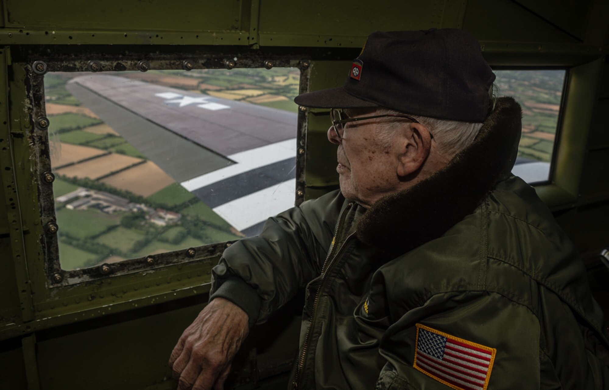Leslie Cruse, a veteran U.S. Army pilot who flew on D-Day, looks out the window of a C-47 Skytrain during a flight over Normandy, June 5, 2014. Bill Prindible was visiting Normandy as part of the 70th Anniversary of the Invasion of Normandy. Over 60 Ramstein Airmen have traveled to Normandy, France to celebrate and honor the sacrifices made by veterans of World War II. (U.S. Air Force photo/Airman 1st Class Jordan Castelan)