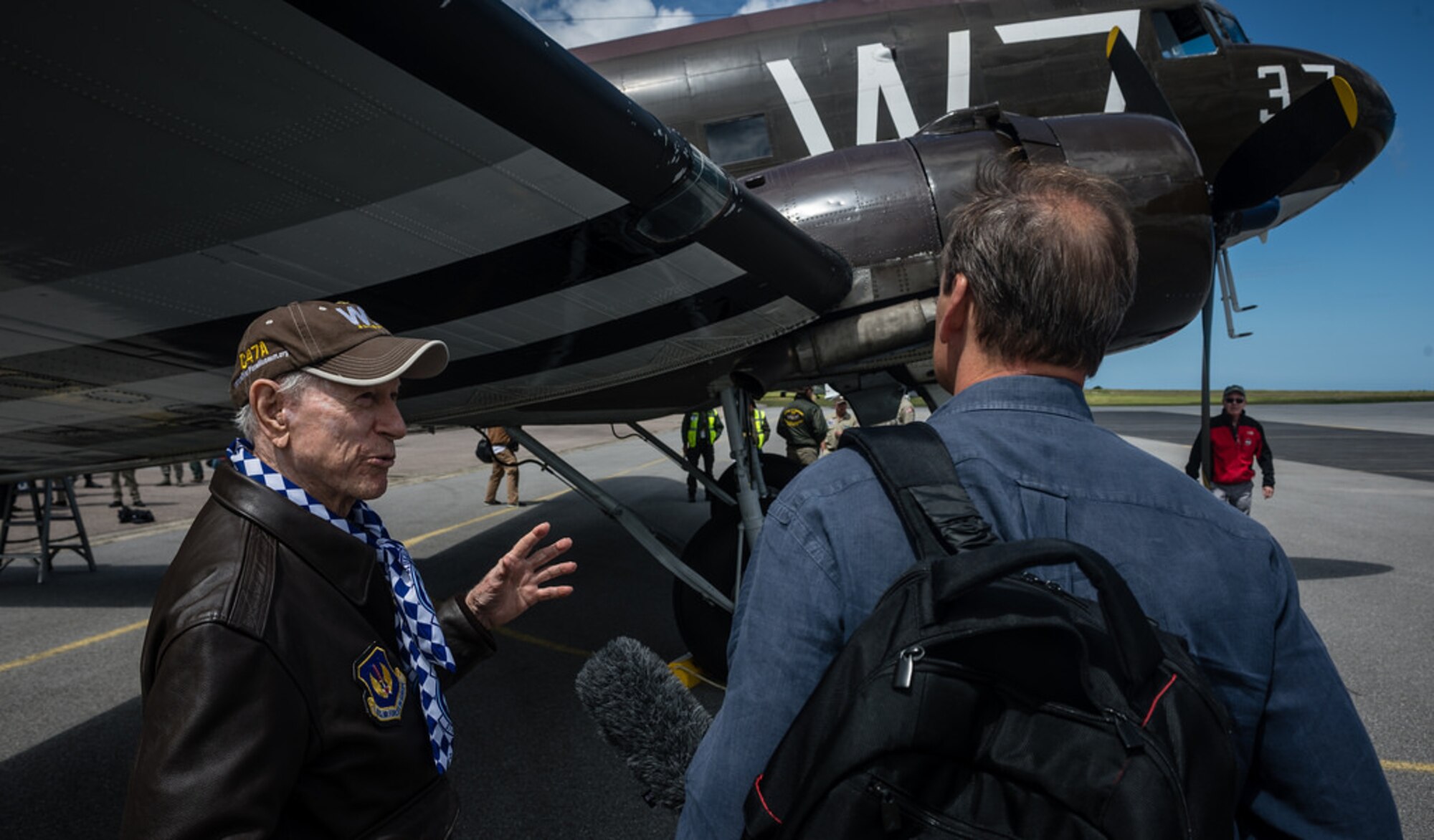 Julian “Bud” Rice, a pilot who flew on D-Day, answers questions from a reporter after a flight over Normandy inside a C-47 Skytrain that flew during D-Day, June 5, 2014. Over 60 Ramstein Airmen have traveled to Normandy, France to celebrate and honor the sacrifices made by veterans of World War II. (U.S. Air Force photo/Airman 1st Class Jordan Castelan)