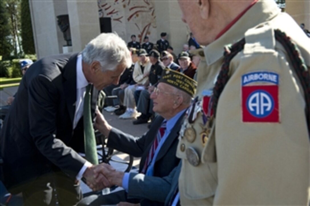 U.S. Defense Secretary Chuck Hagel meets with veterans from several nations during a ceremony commemorating the 70th anniversary of D-Day in Normandy, France, June 6, 2014. 