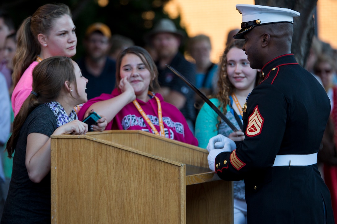 Staff Sgt. Dean Edwards, ceremonial hoster, talks to guests prior to a Friday Evening Parade at Marine Barracks Washington, D.C., June 6, 2014. (Official Marine Corps photo by Cpl. Larry Babilya/Released)
