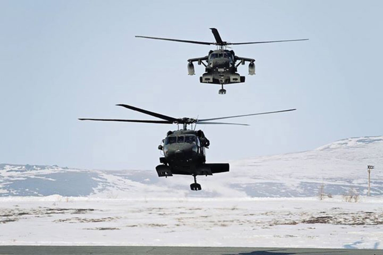 A pair of Alaska Army National Guard UH-60 Black Hawk helicopters taxi after pilots land at the Alaska Army National Guard Army Aviation Support Facility in Nome April 17, 2012. A similar craft rescued a stranded hiker on June 5, 2014.