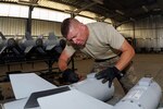 ir Force Staff Sgt. Tim Alewine, a munitions specialist with the 451st Expeditionary Maintenance Squadron, makes necessary adjustments to the tail assemblies of a GBU-38 Joint Direct Attack Munitions at the Tri-National Ammunition Supply Point June 15, 2012. Alewine is currently deployed from the 169th Fighter Wing out of McEntire Joint National Guard Base, S.C., supporting Operation Enduring Freedom. "Swamp Fox" F-16 Fighting Falcons, their pilots, and support personnel began their air expeditionary force deployment in early April to take over the air tasking order and provide close air support for troops on the ground in Afghanistan.